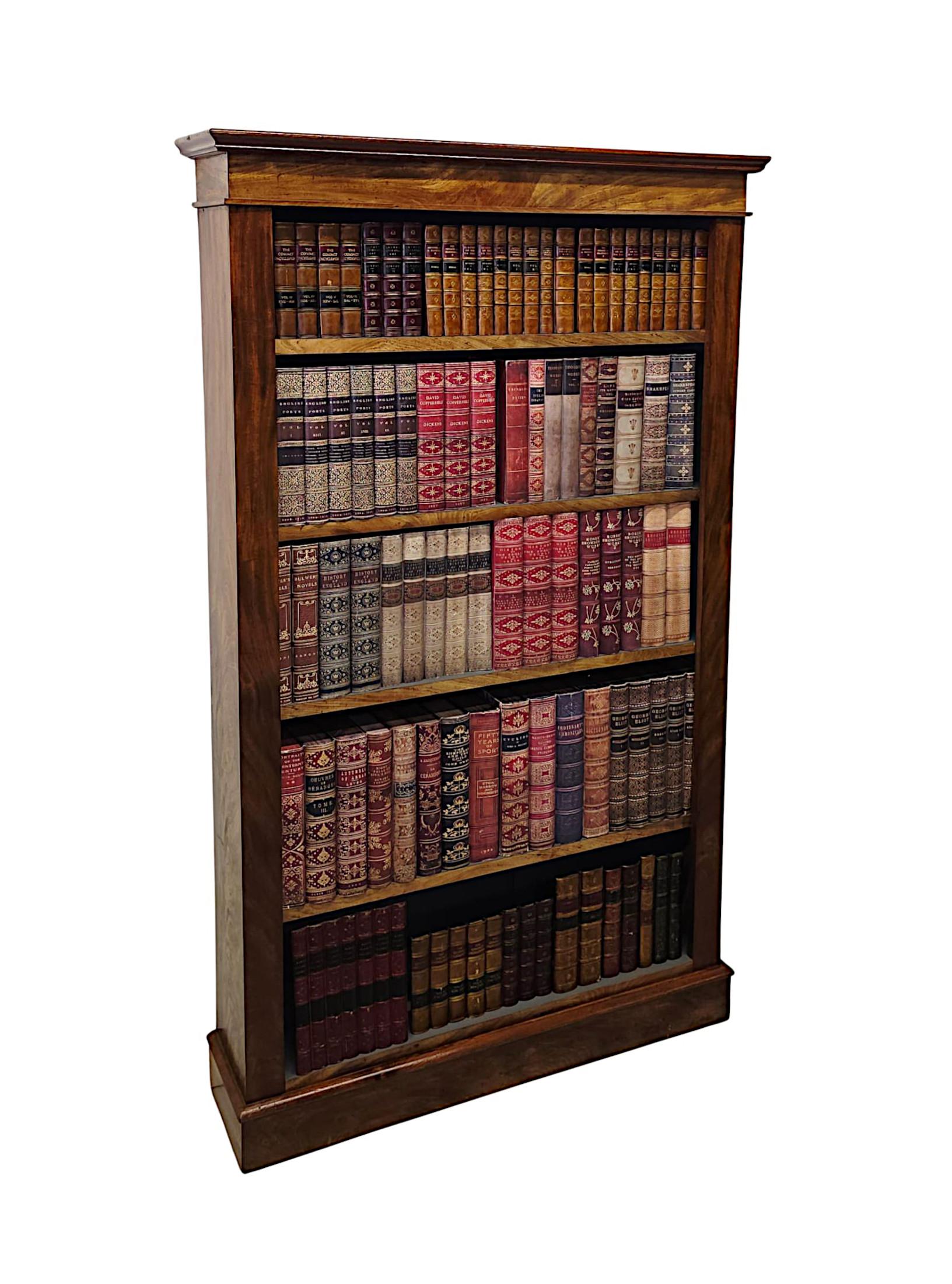 A gorgeous 19th Century Century well figured mahogany open bookcase of neat proportions, finely hand carved with beautifully rich patination and fine grain.  The moulded and stepped cavetto pediment is raised over an elegantly simple frieze above