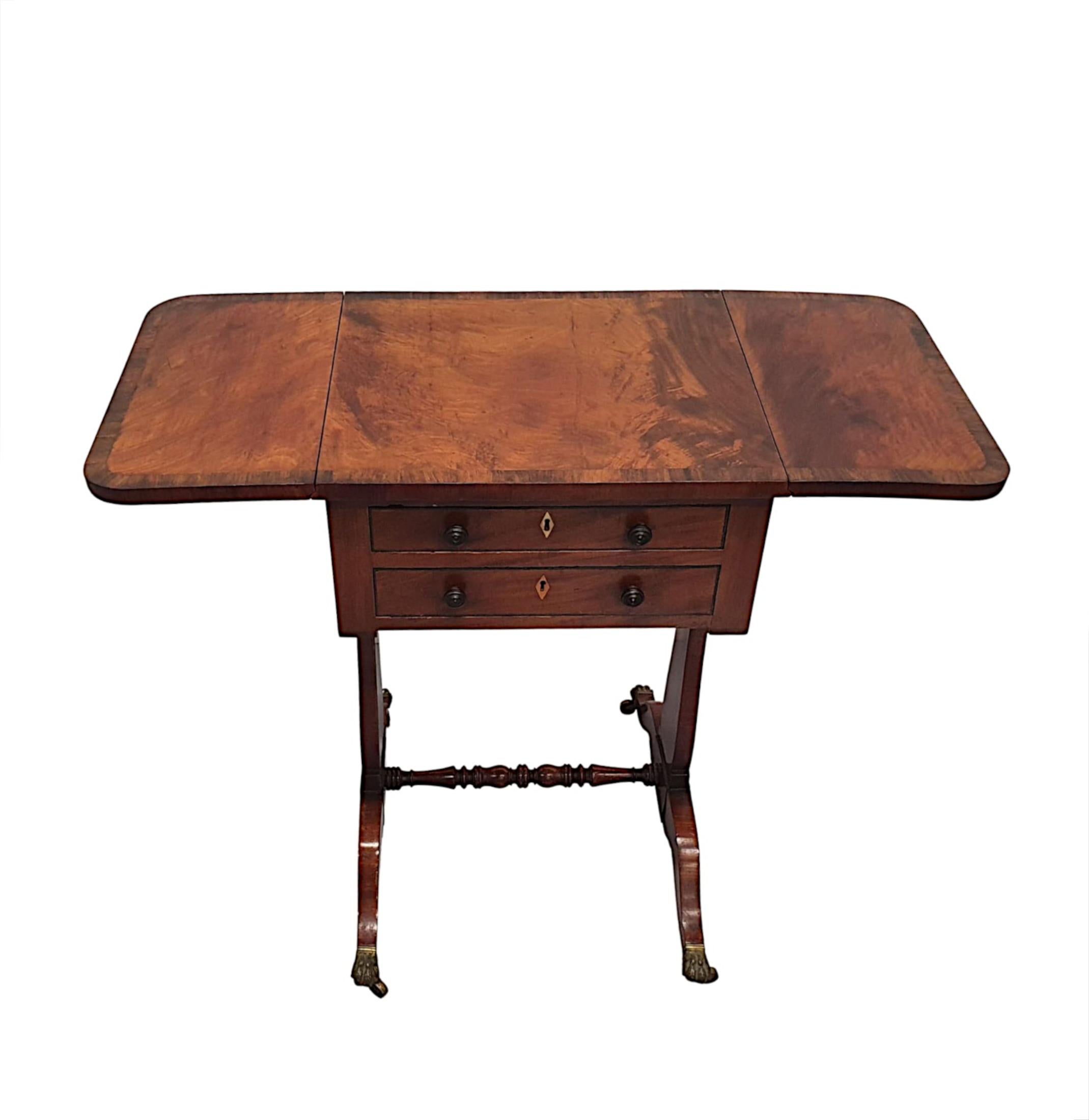 A gorgeous 19th century mahogany and fruitwood occasional or sofa table of neat proportions, finely hand carved and of fabulous quality with rich patination and grain. The well figured moulded and crossbanded top of rectangular form with twin hinged