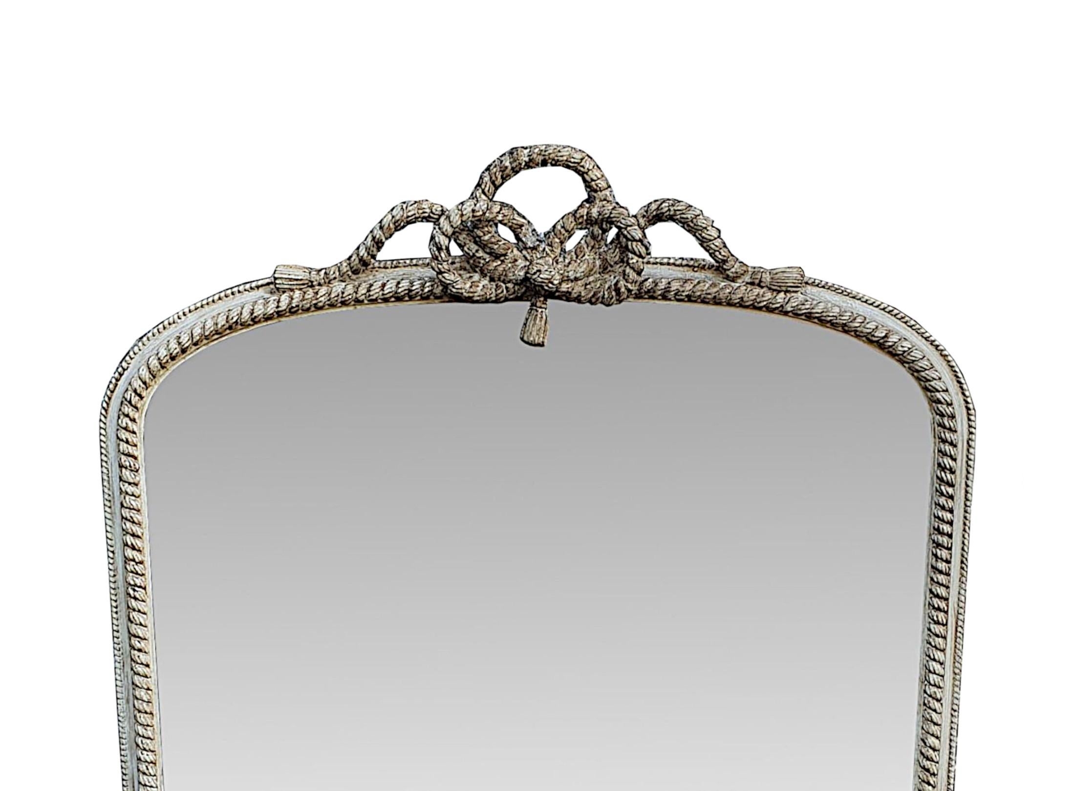 A gorgeous 19th century overmantle mirror of large proportions, beautifully restored in a distressed paint finish. The original mercury glass mirror plate with some mottling, is set within a finely hand carved and moulded giltwood frame with beaded