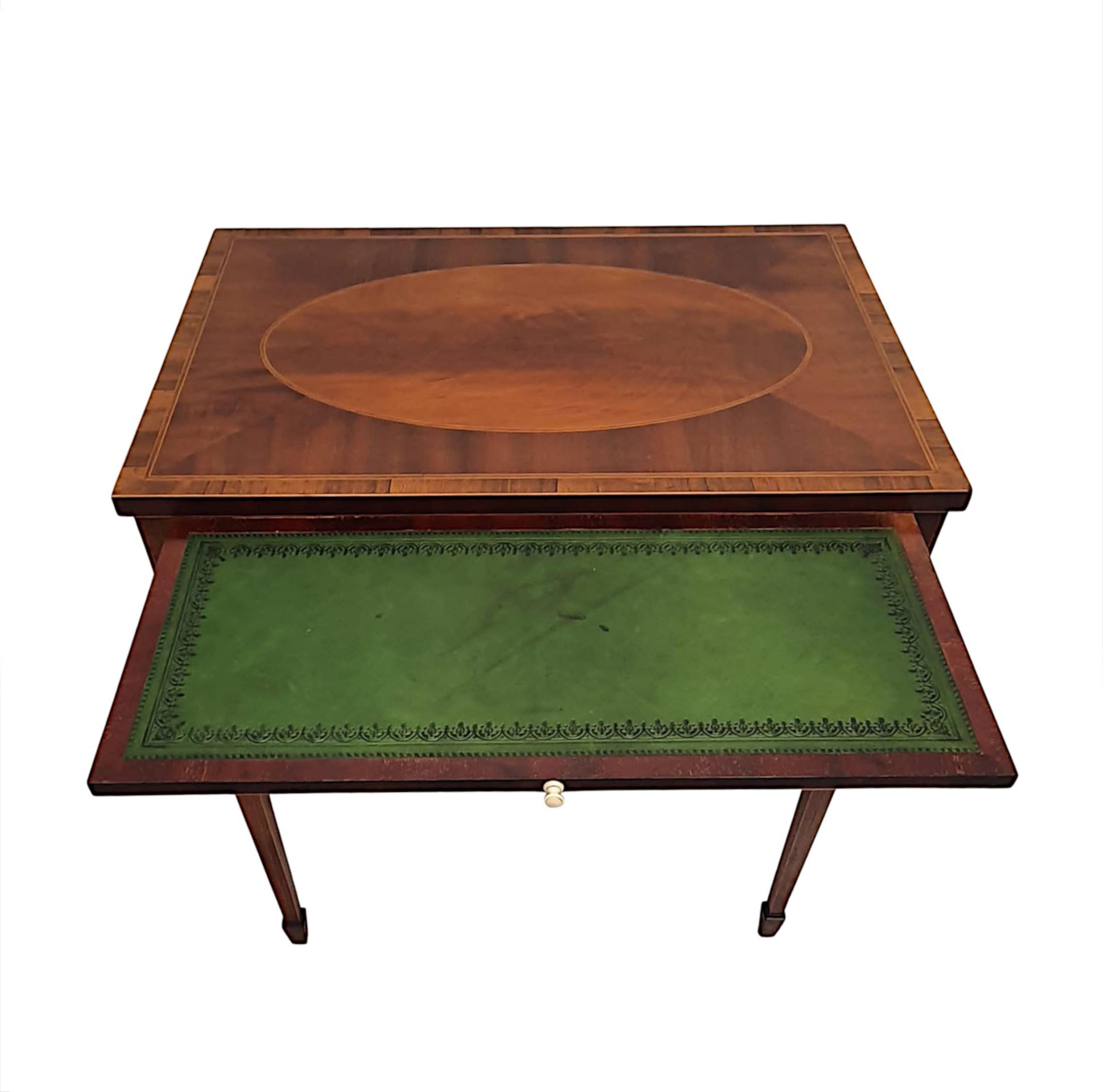 A gorgeous Edwardian inlaid side or writing table, finely carved and of fabulous quality with richly patinated timbers comprising of mahogany and fruitwood. The moulded cross banded, quarter veneered top of rectangular form with a lovely inlaid oval
