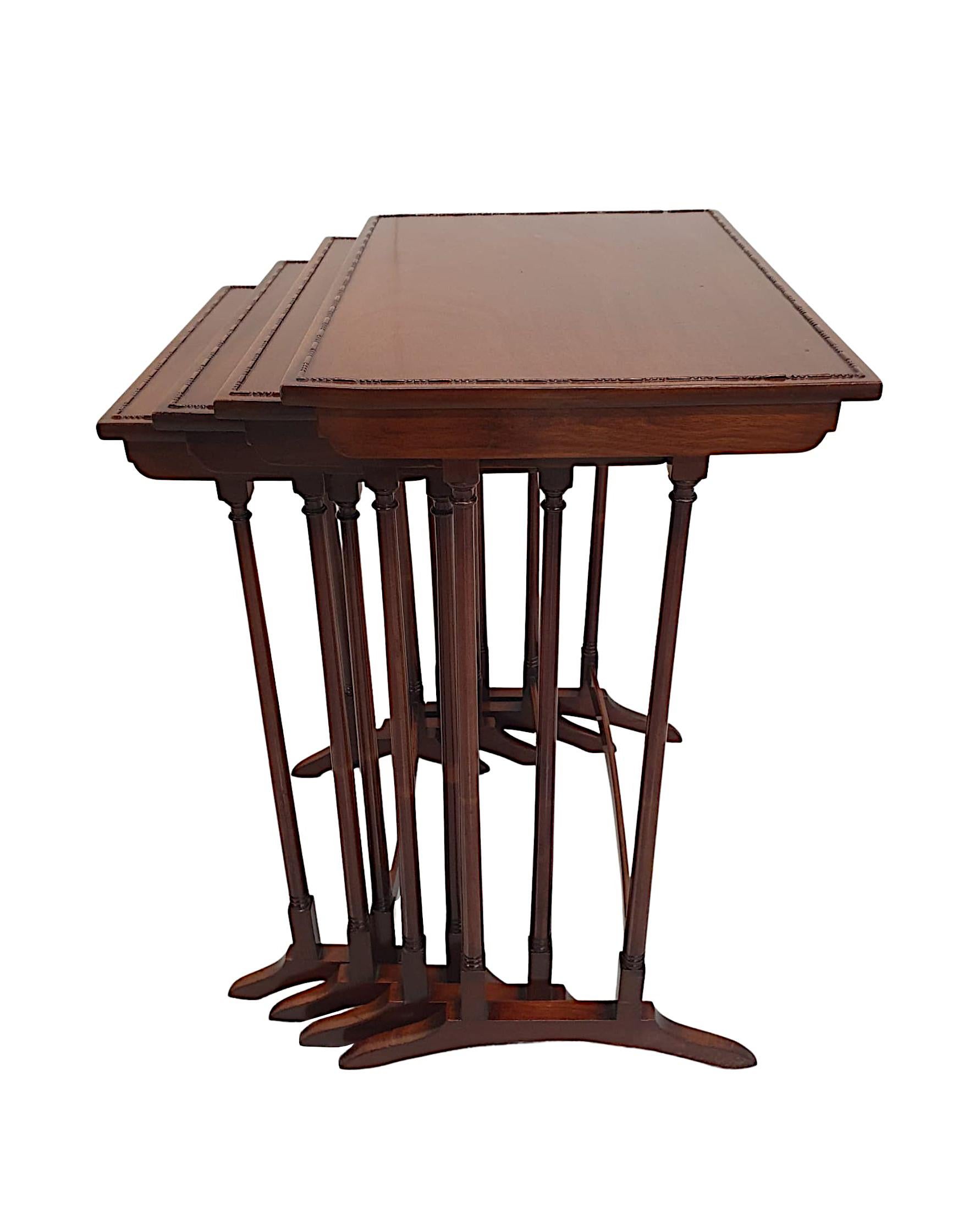 A gorgeous Edwardian nest of four mahogany tables, of exceptional quality, fully restored and fabulously carved with beautifully rich patination.  The well figured, fine grained top of rectangular form with a delicate, decorative border of lozenge