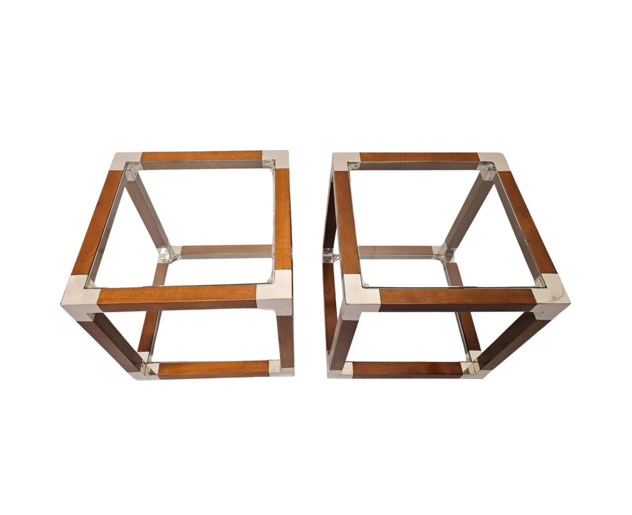 Un precioso par de mesas auxiliares de cristal, madera de cerezo y cromo de excepcional calidad y forma cuadrada con un diseño sencillo y sorprendentemente limpio.  La encimera acristalada y el estante inferior están colocados dentro de un fabuloso