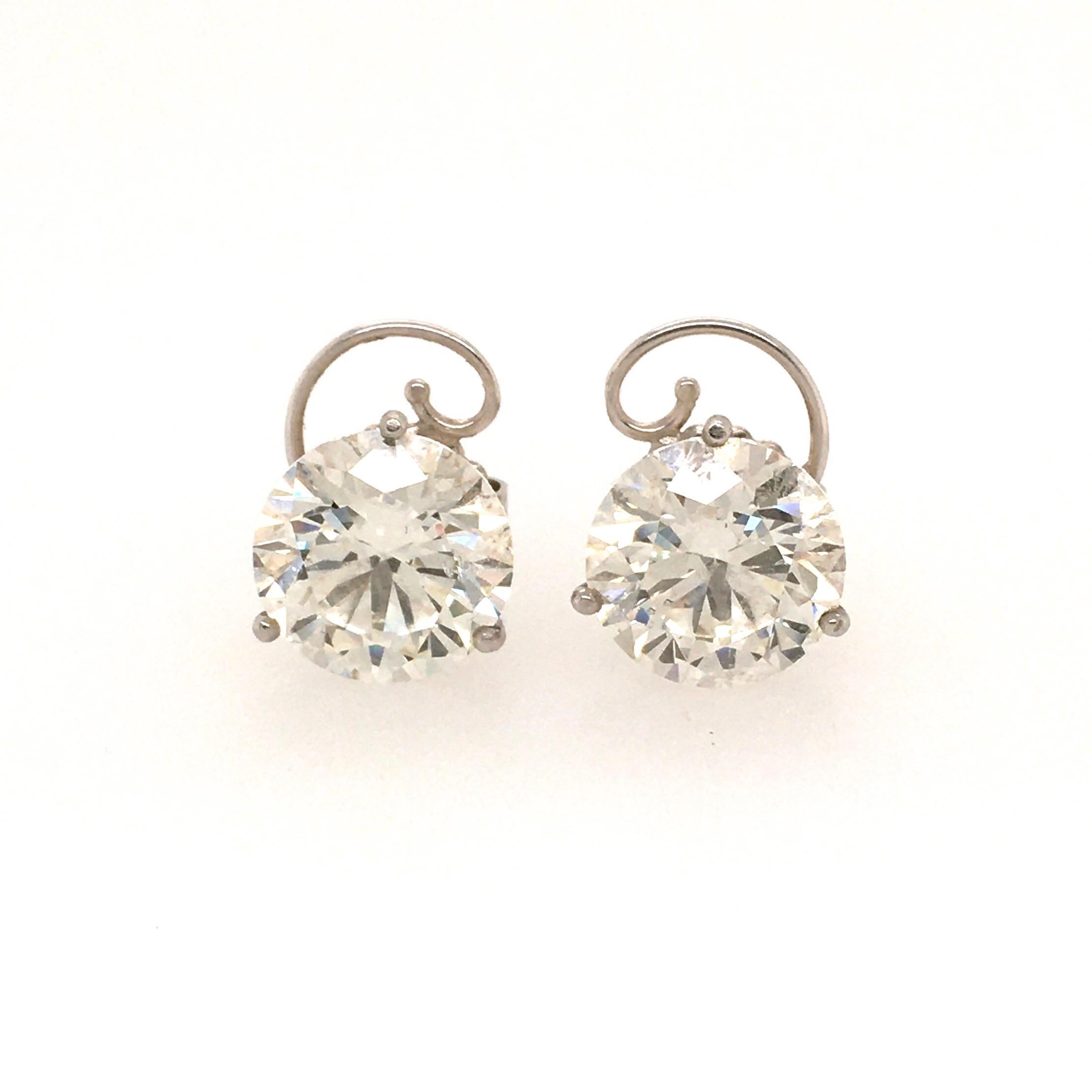 A pair of platinum and diamond ear studs, weighing 6.02 carats and 6.03 carats, J SI2. In a martini setting. Gross weight is approximately 5.4 grams.

GIA issued a Diamond Grading Report for each diamond.  
Report 1258703365, dated June 28, 2019,