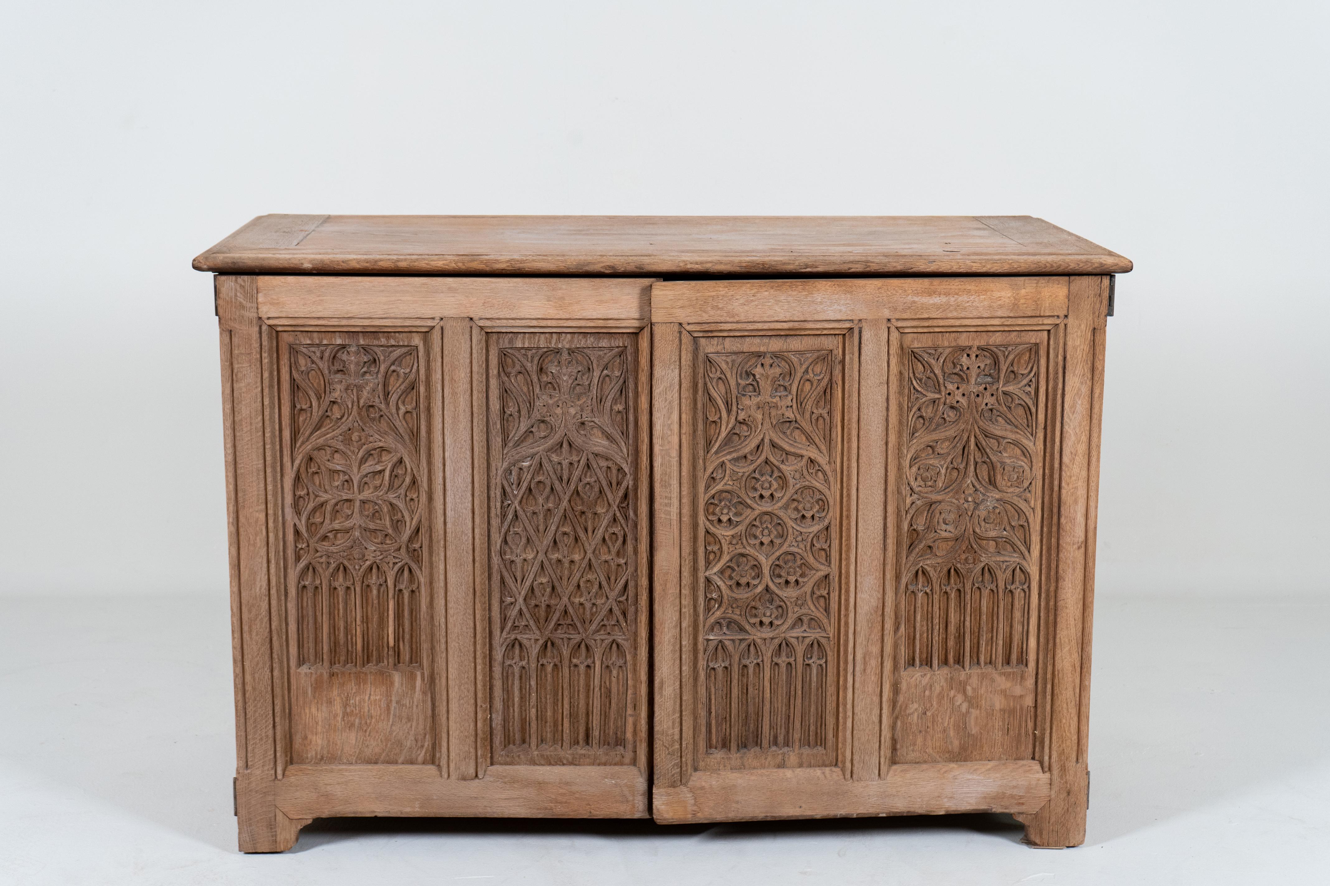 This remarkable Gothic-style chest is intricately carved in stone-inspired tracery and solidly built.   The Gothic Revival style was popular in Europe in the second half of the 19th Century.   As Europe modernized (especially France and Britain)  a