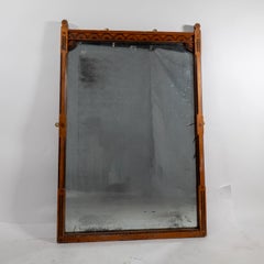 A Gothic Revival oak and inlaid wall mirror with the original mercury mirror