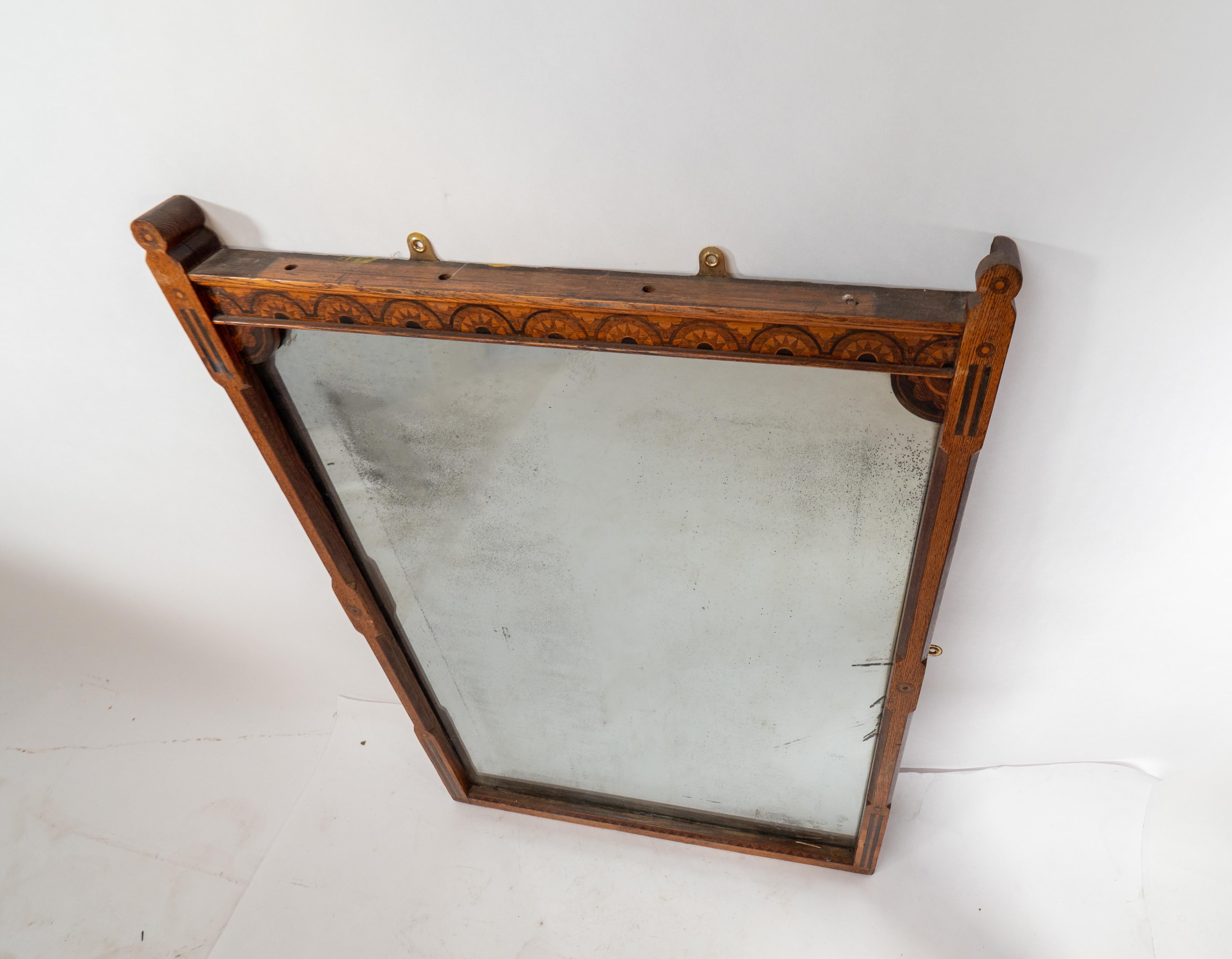 English A Gothic Revival oak and inlaid wall mirror with the original mercury mirror For Sale