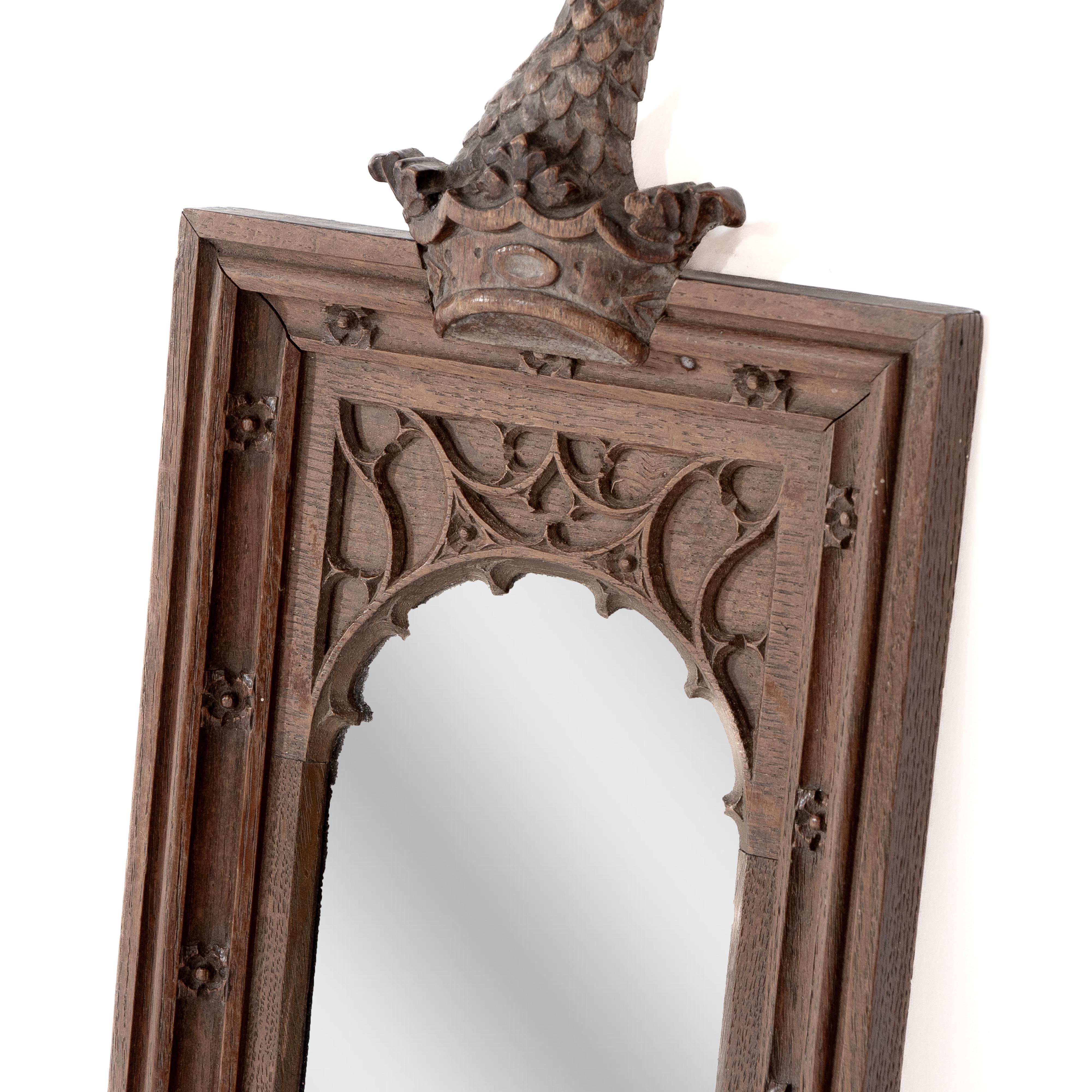 English A Gothic Revival oak mirror surmounted with a carved eagle to the top For Sale