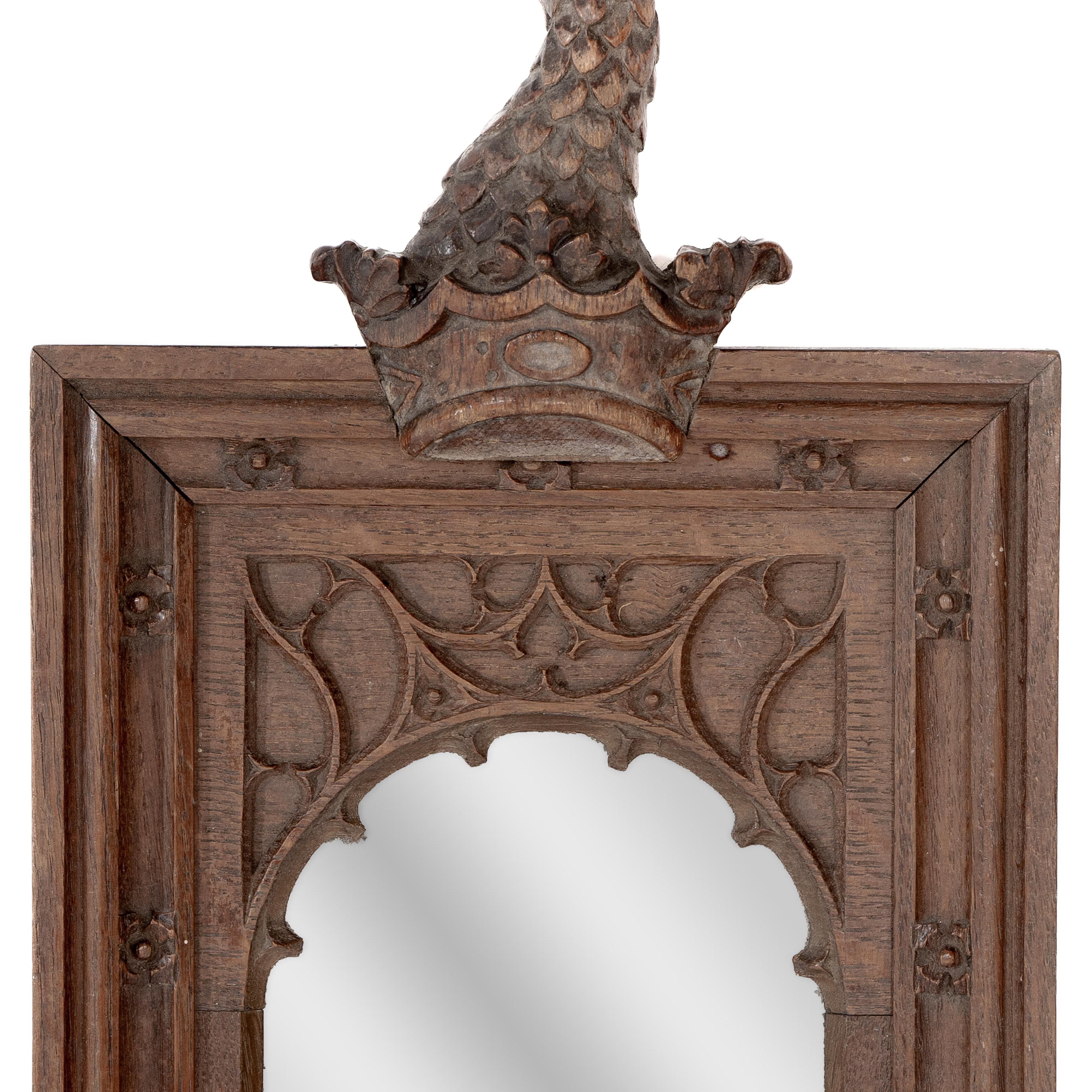 A Gothic Revival oak mirror surmounted with a carved eagle to the top In Good Condition For Sale In London, GB