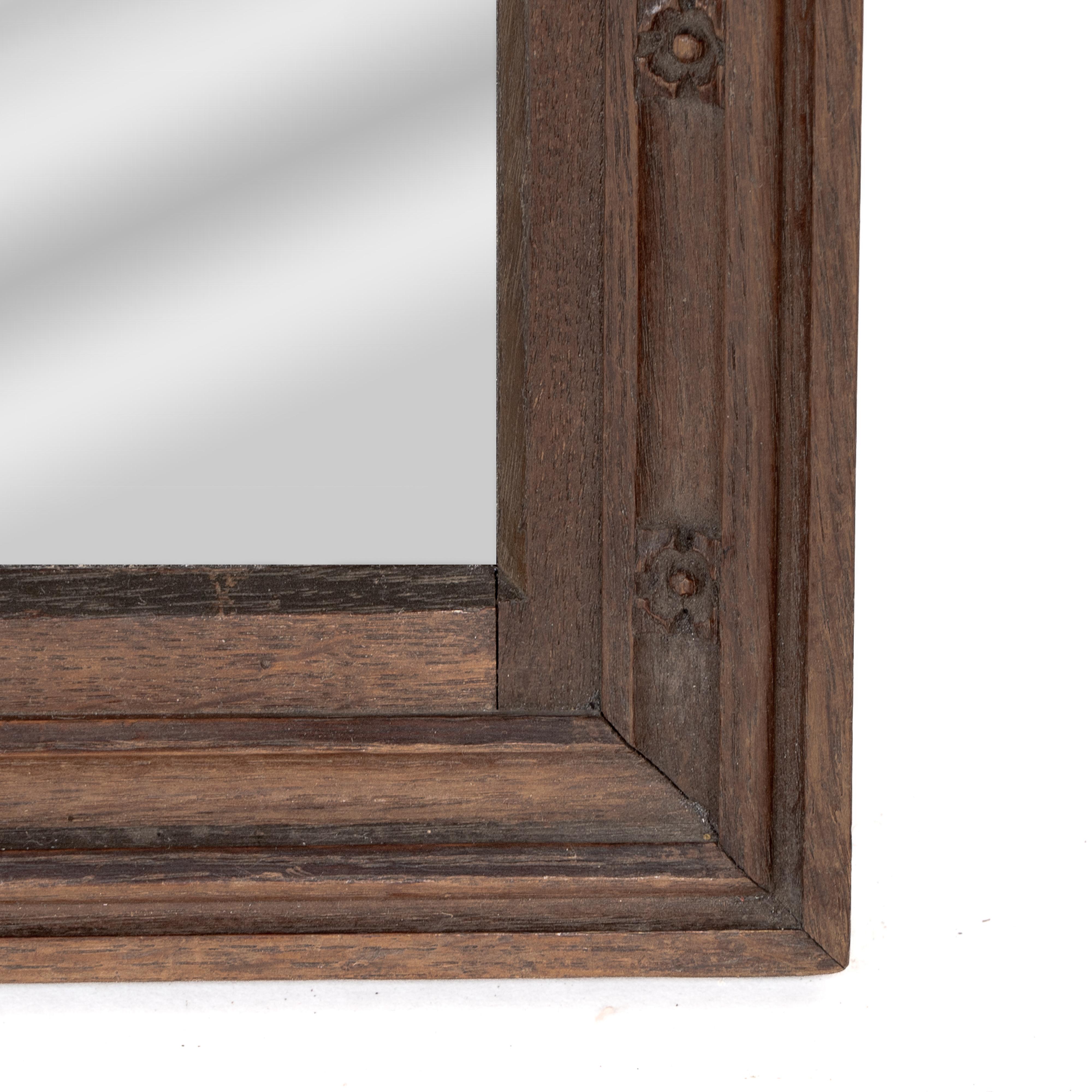 A Gothic Revival oak mirror surmounted with a carved eagle to the top For Sale 1
