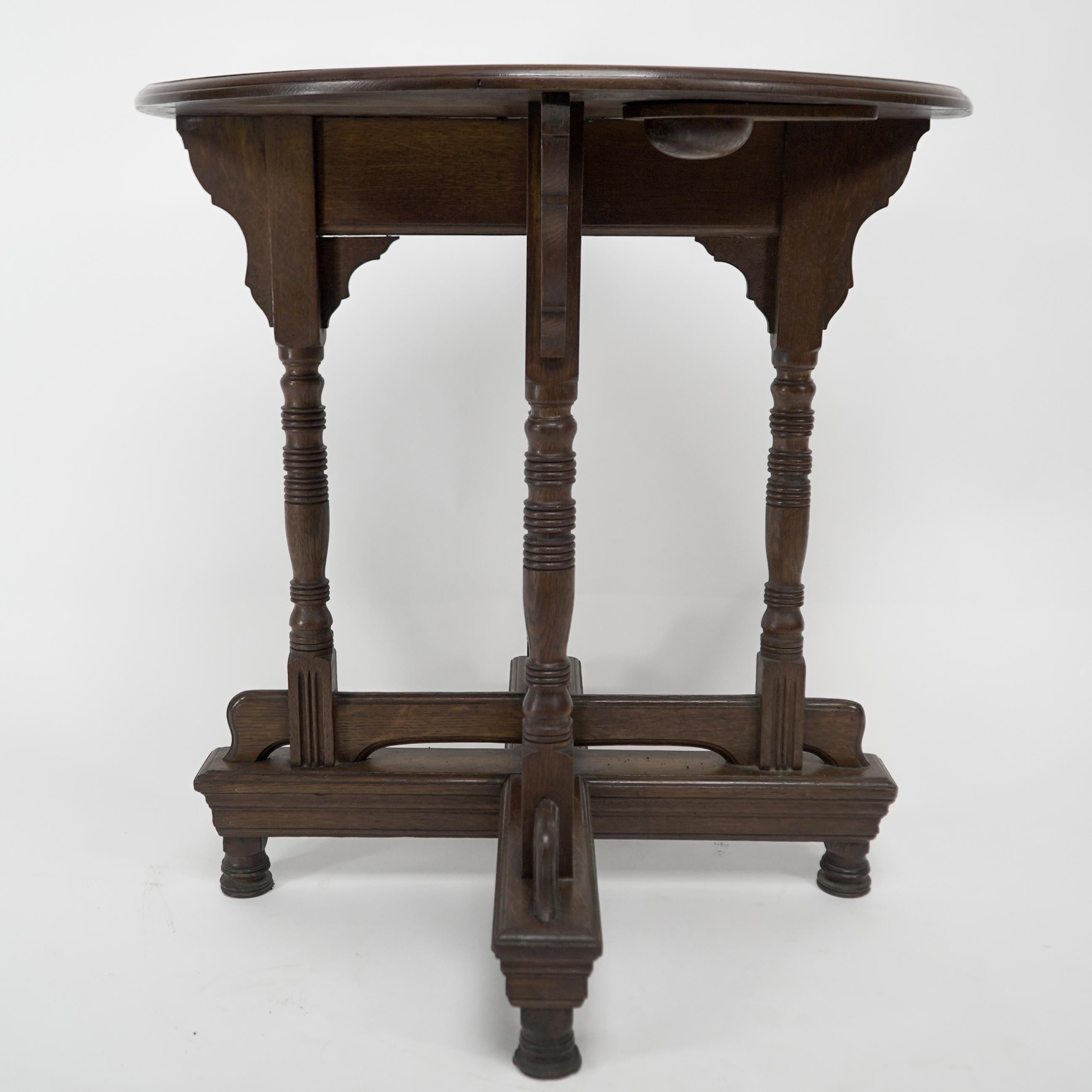 English Alfred Waterhouse. A Gothic Revival oak side table with double cross stretchers. For Sale