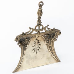 A Gothic Revival solid brass crumb tray with tigers heads and floral decors