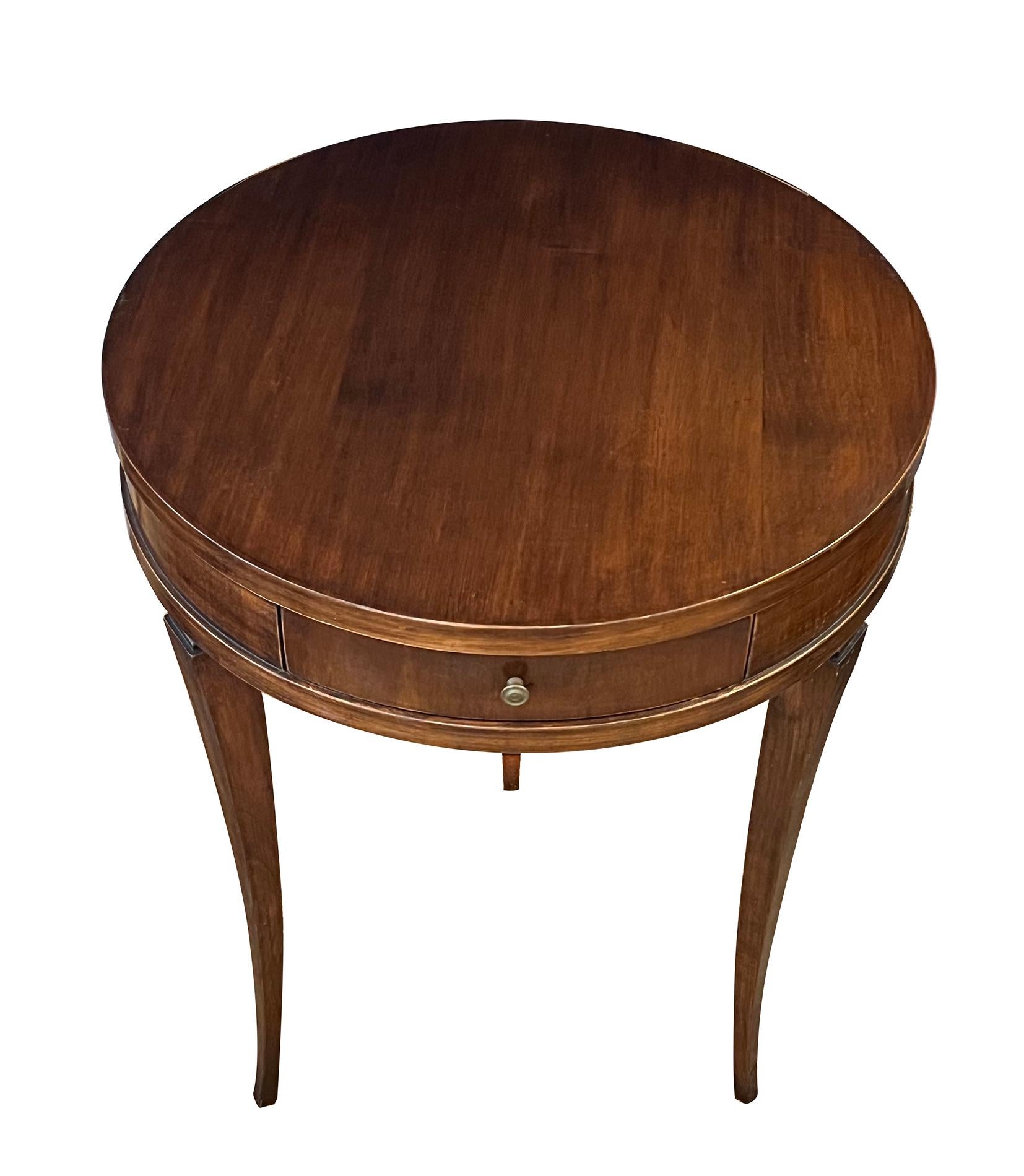 the round top above a plain frieze apron fitted with a single drawer; raised on a tripod base of elegantly splayed and tapering supports with a waisted neck