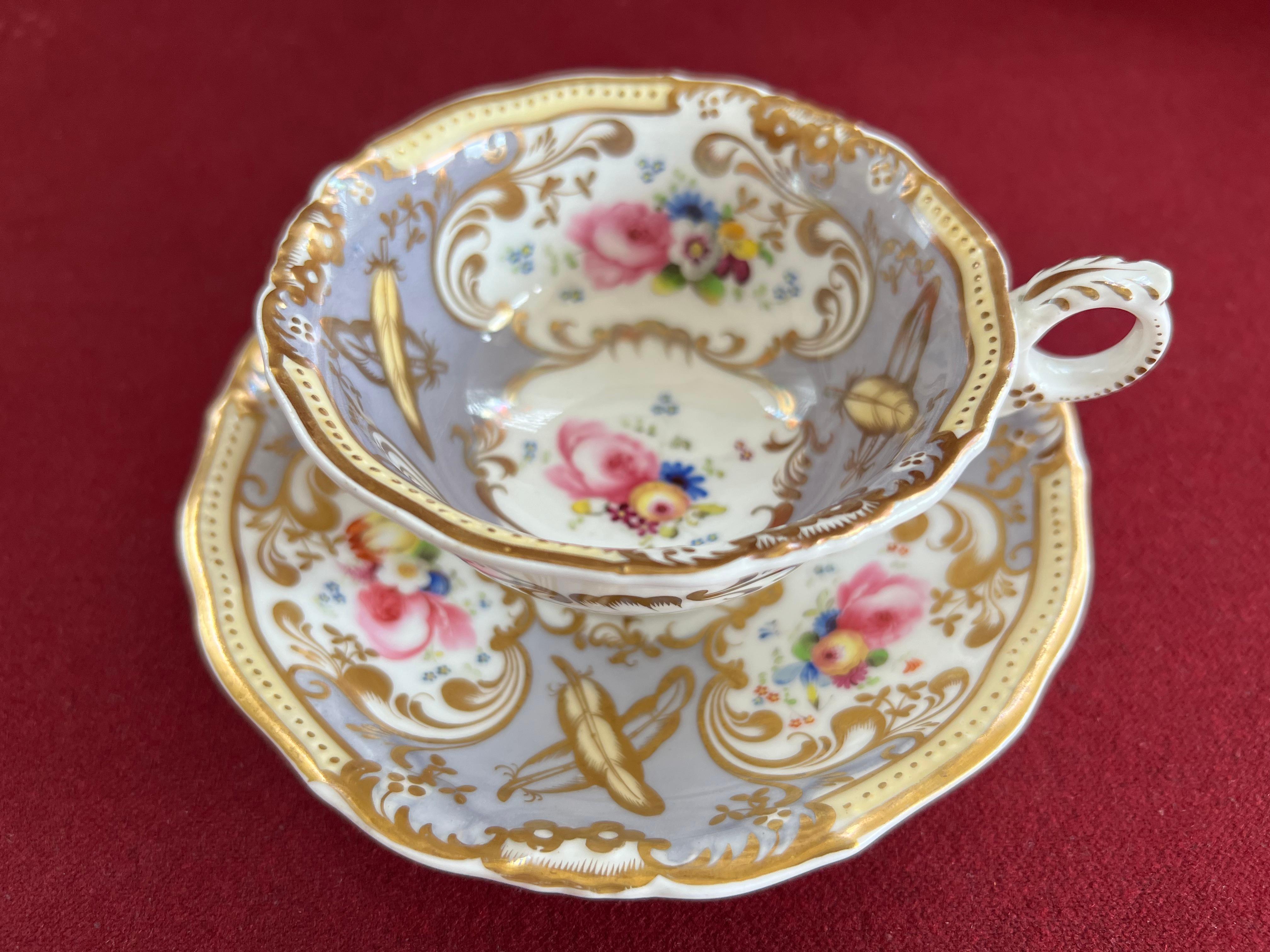 A Grainger's Worcester Porcelain 'Gloster' Shape Part Tea Set c.1835-1840. Finely decorated with panels of flowers on a grey ground and yellow and gold painted feathers.

Consisting of:

1 teapot and lid

3 tea cups

4 saucers 

1 coffee