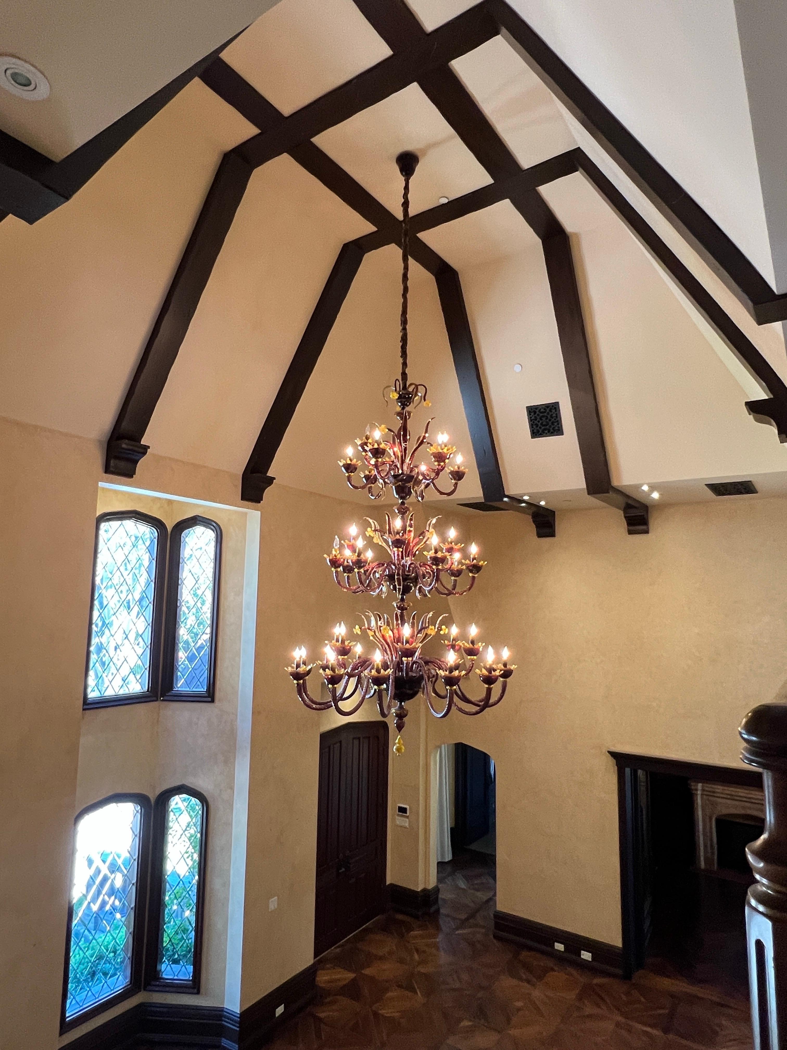 A Grand Custom-Commissioned Murano Amethyst & Amber 36-light Chandelier & 12 Matching Sconces

A magnificent and monumental Murano chandelier of triple tiered construction, composed of multiple scrolling arms with flame shaped bulbs issuing from a
