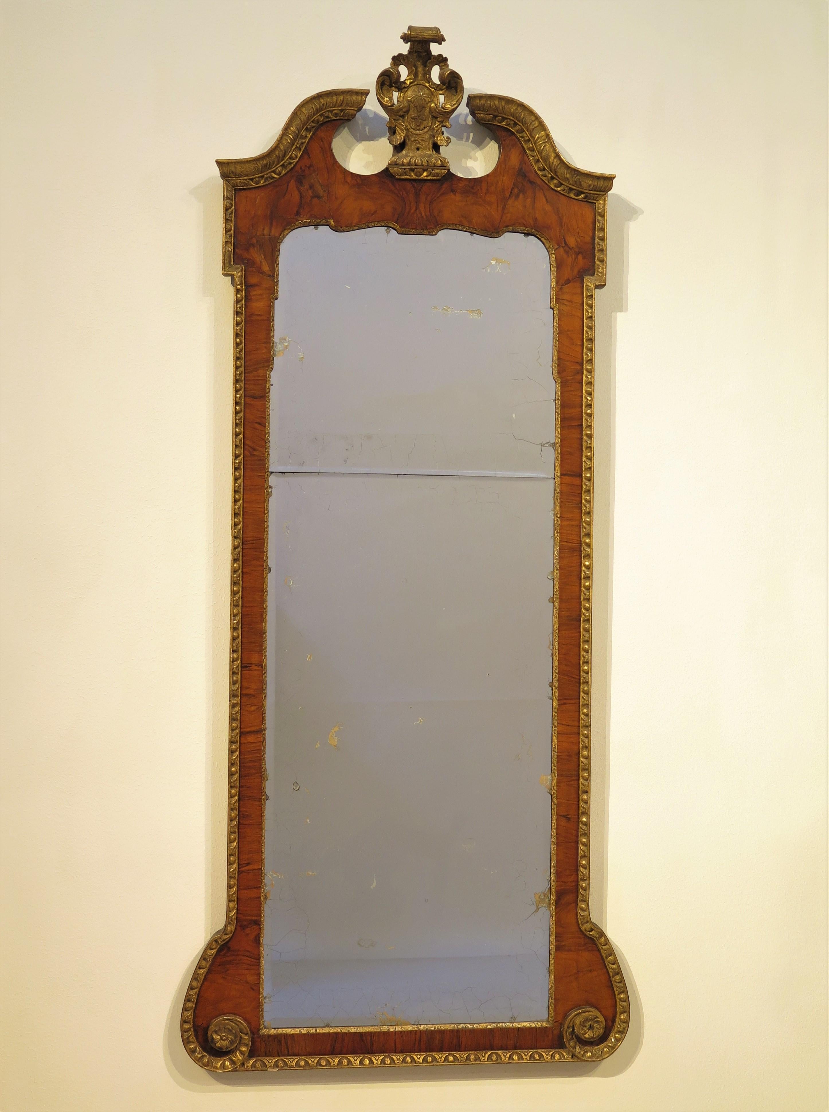 large, just over 6' tall,  George II walnut pier mirror / looking glass with swan's neck pediment and center crest / cartouche, book matched walnut veneers, having two beveled glass mirrored plates with gilt edging, beautiful patina, mellow gilding,