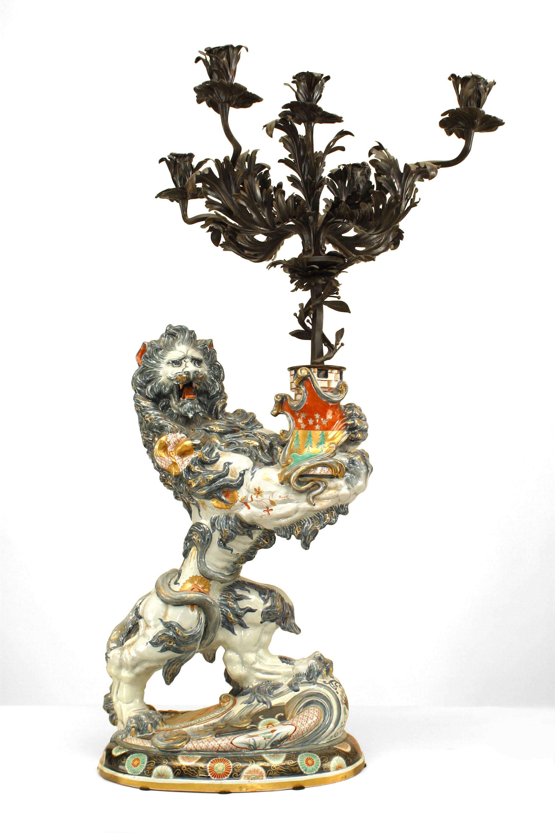 Pair of French Victorian (19th Century) large porcelain lion figures holding wrought iron candelabras (signed by EMILE GALLE 