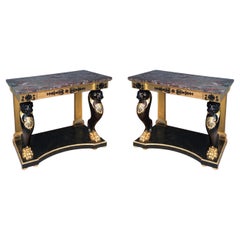 A grand Pair of 19th Century Regency Gilt and Ebonized Console Tables