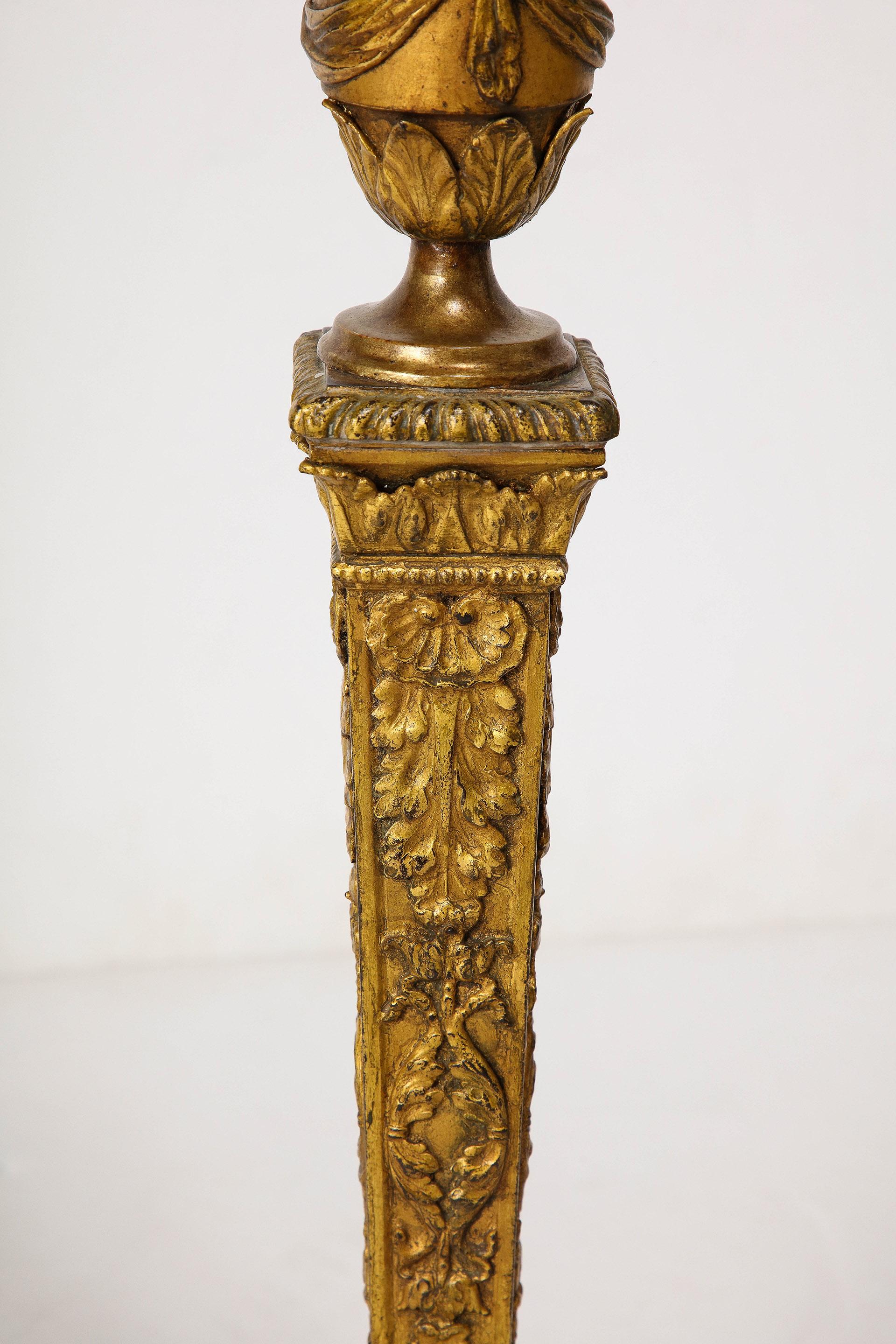 Cast A Grand Pair of Empire Style Gilt Iron Candlesticks For Sale
