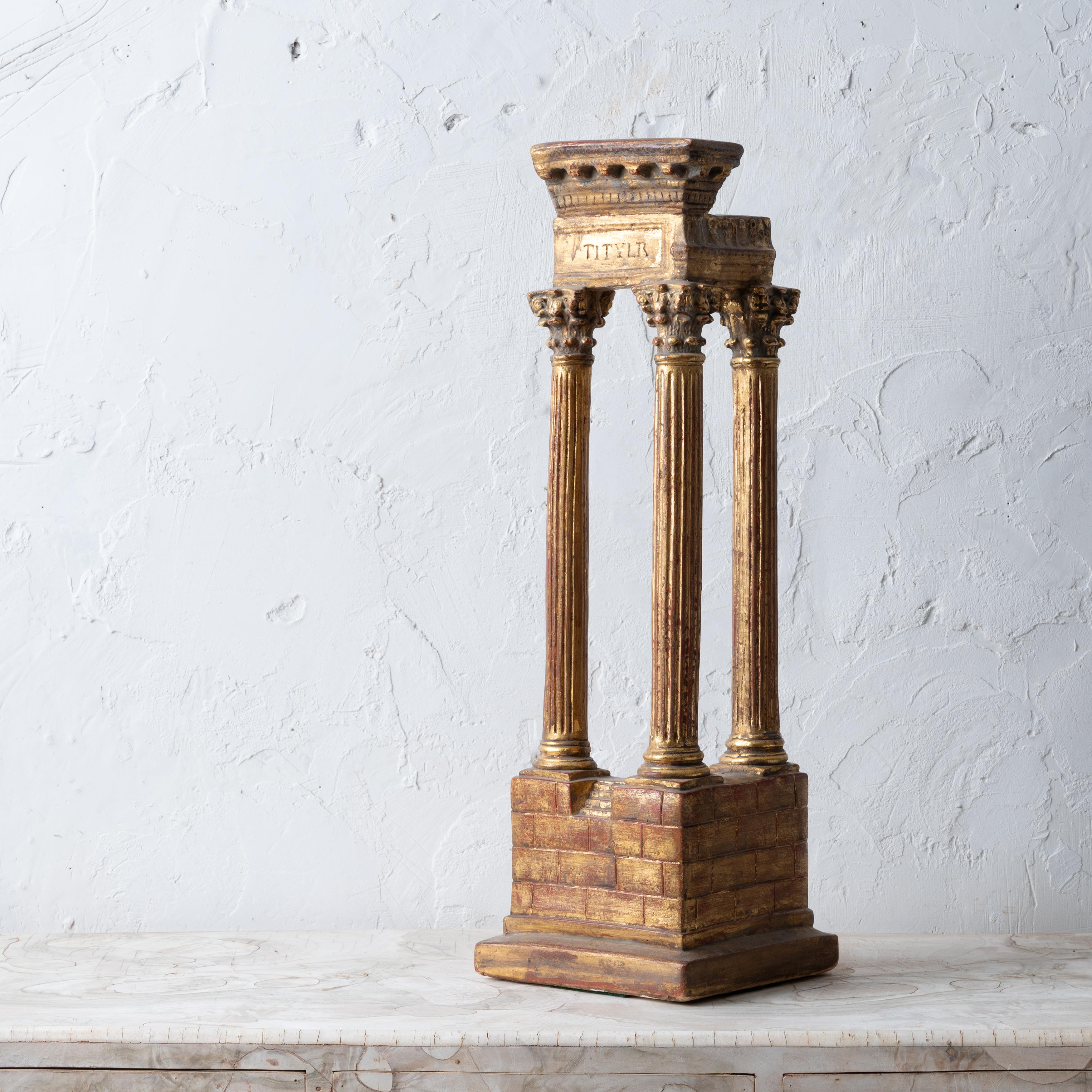 A modern grand tour souvenir gilded plaster model of the Temple of Vespasian, circa 1950s.

8 by 8 by 25 ¼ inches tall


