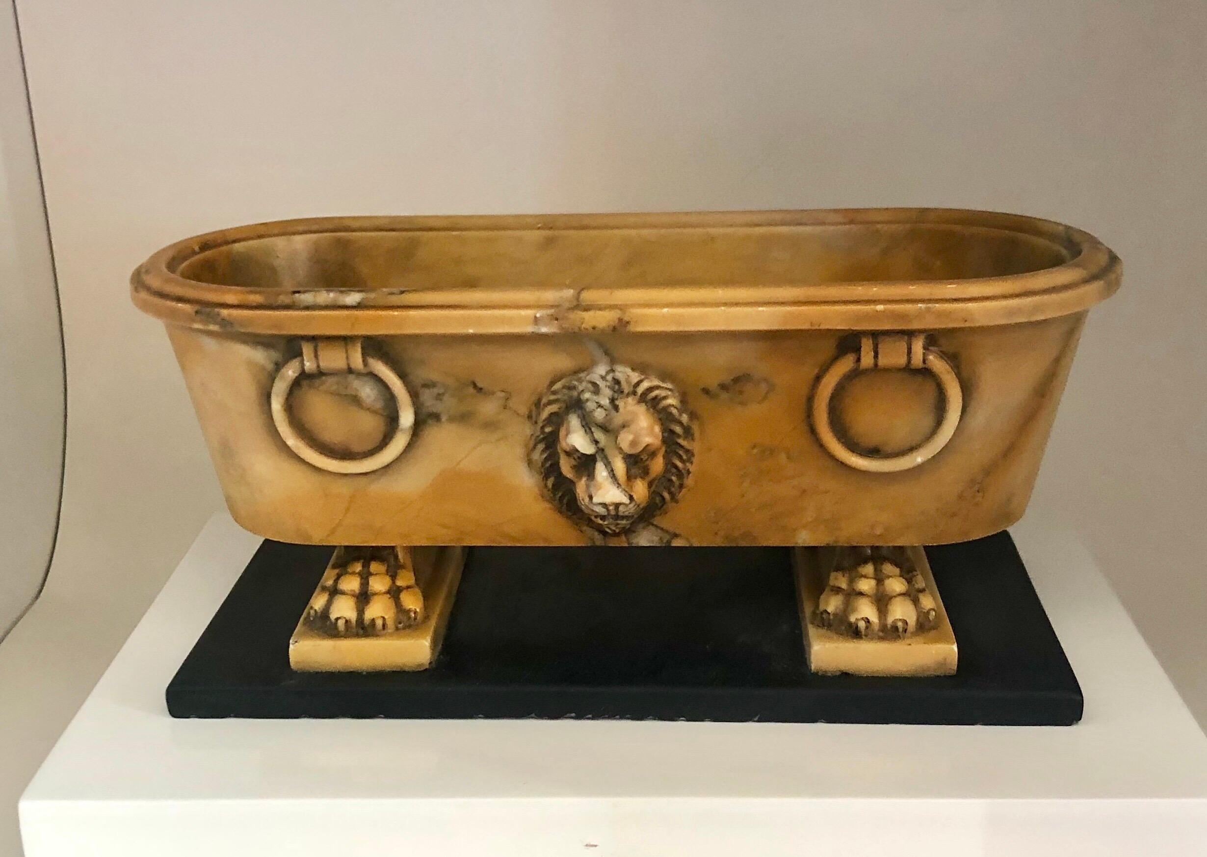 The miniature model with lion’s head’s centered on both sides, and 2 pairs of carved faux ringed handles resting on lions’s paw feet.