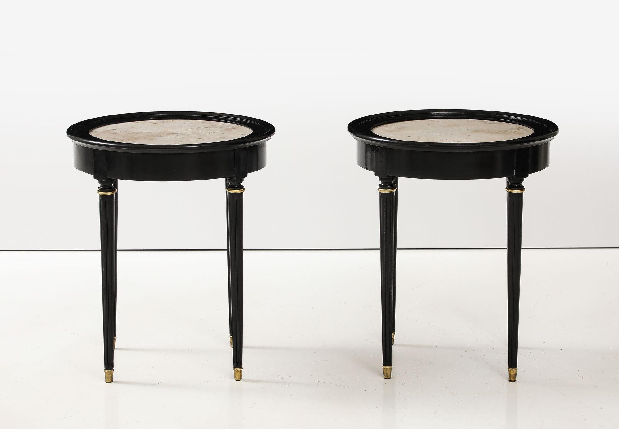 A great Pair of Black Lacquer Marble Top Circular Side Tables. A pair of marble tops are set in a black lacquer frame on four tapering legs capped in brass. In the manner of Andre Arbus
23.75