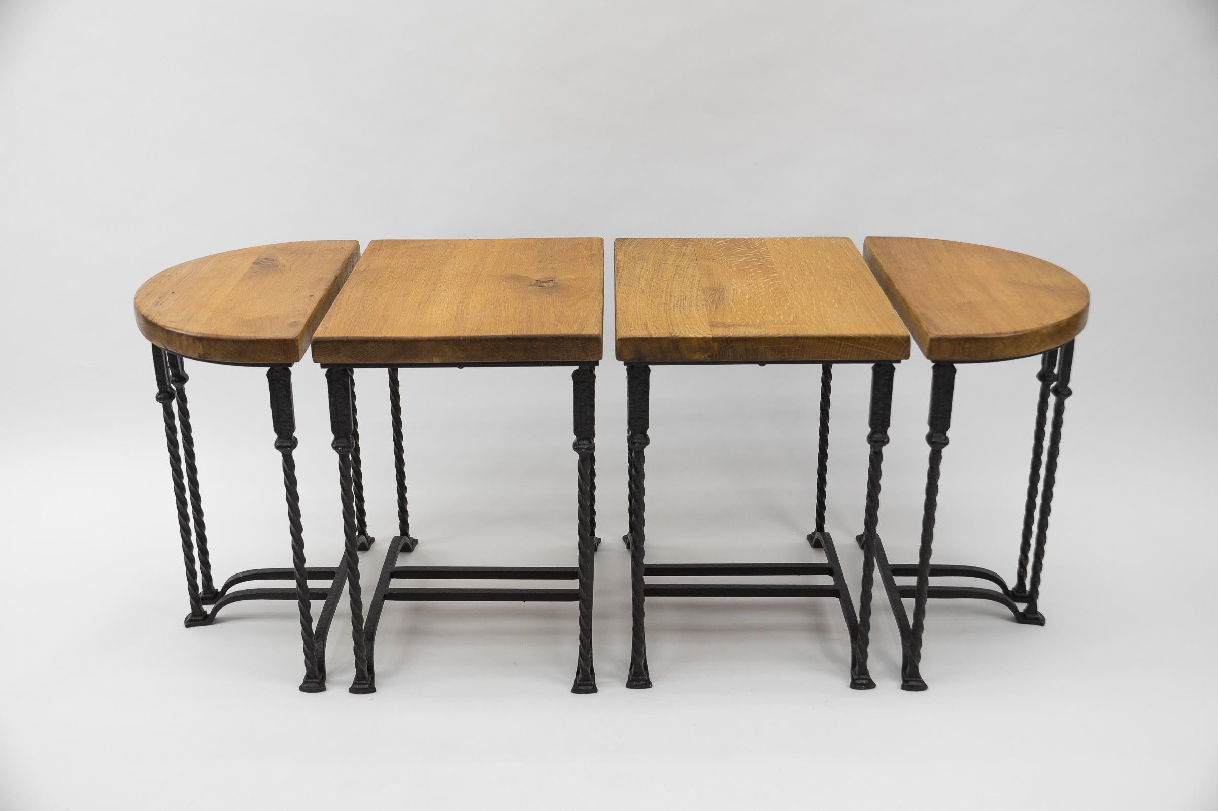 Cast iron and massive oak. 

Very good condition.
The rectangular tables are 35x45cm and the semicircular ones are 25x35cm. Height of each 51cm.