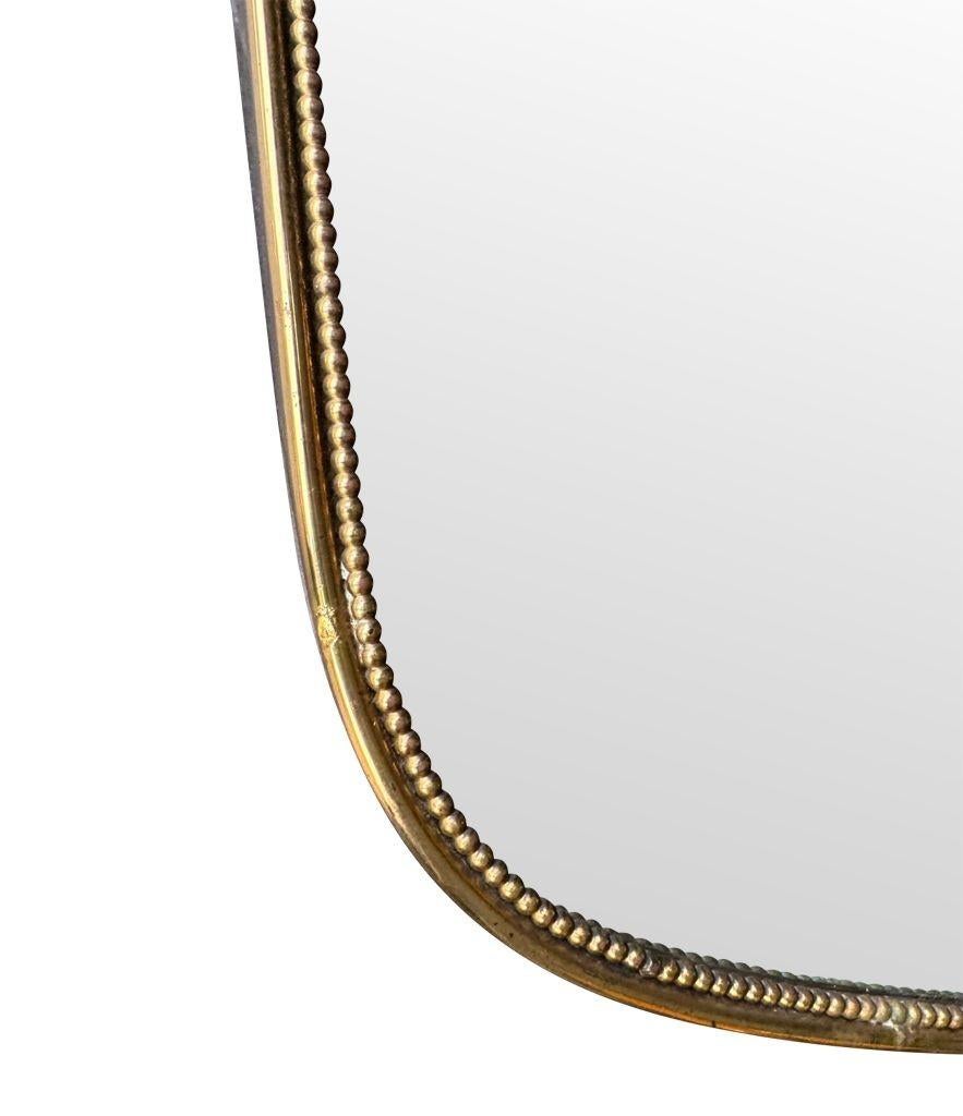 A great shaped orignal Italian 1950s shield mirror with brass beaded frame 1