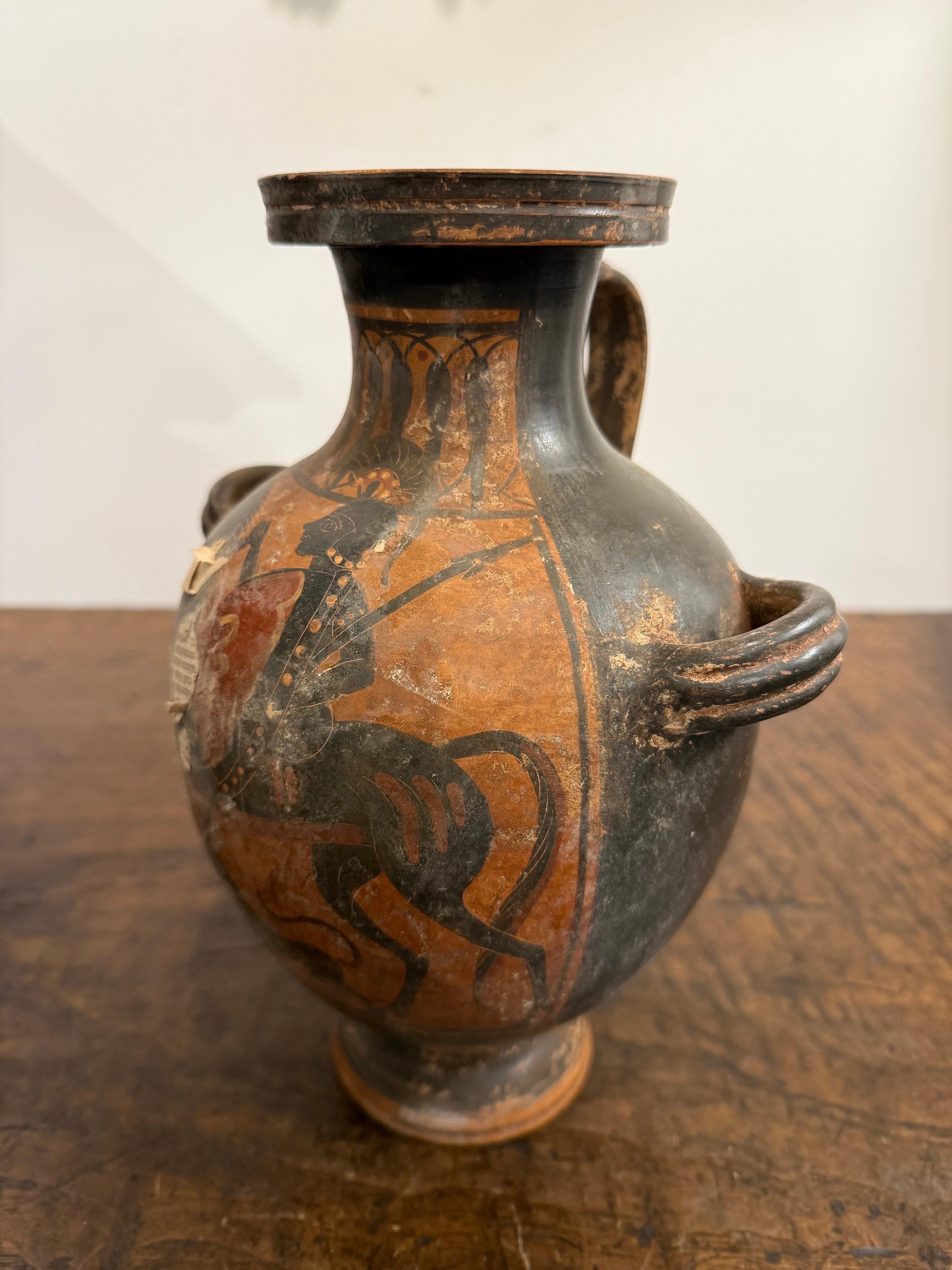A Greek Black Figure Style Grand Tour Hydria, 19th Century

Provenance: Private Australian Collection.

Description:
Depict a heroic subject, possibly related to figures like Achilles or Ajax, given the presence of warriors and the style of the