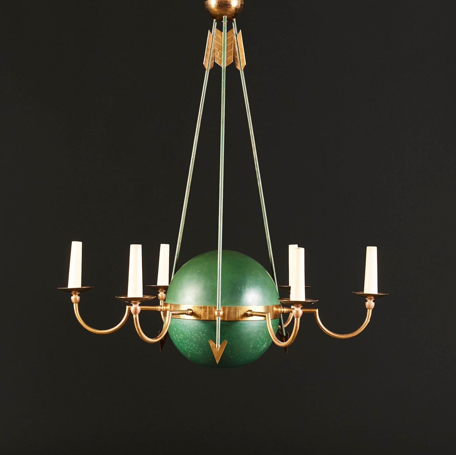 An unusual early twentieth century Empire style six arm chandelier with central green lacquer sphere held by three upright arrows, the curved brass arms terminating in drip trays holding the candles. Now converted for electricity.
