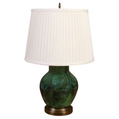 A Green Ceramic Lamp on a Brass Base