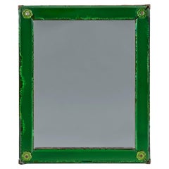 A green glass art deco mirror of small scale
