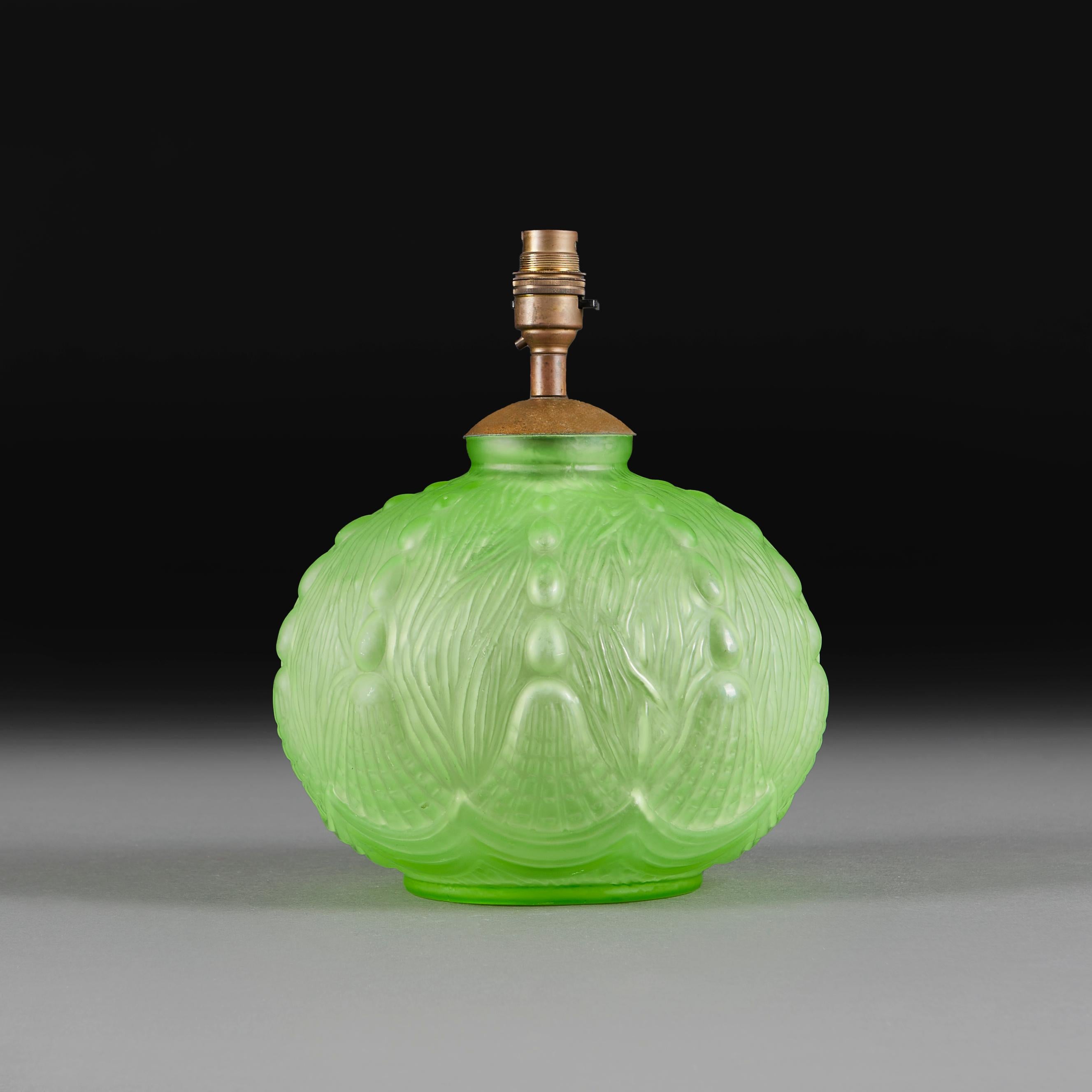 An early twentieth century glass vase decorated in the Art Deco manner, of globular form.

Please note:

Lampshade not included. Lamp photographed with a 14” diameter pale cream card Pembroke lampshade.

Currently wired for the UK with patinated