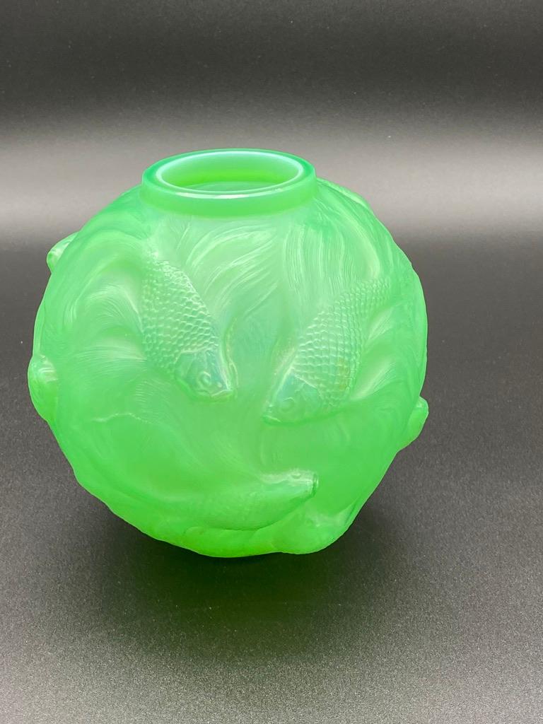 One of René Lalique's iconic vases, the Formose vase.

The Formose vase has been created in many colors and is as the Ronce vase, the perfect piece to collect in colors.

On the Formose's body, small Chinese fishes are shown swimming