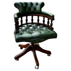 Una sedia girevole da scrivania o sedia da capitano in pelle verde