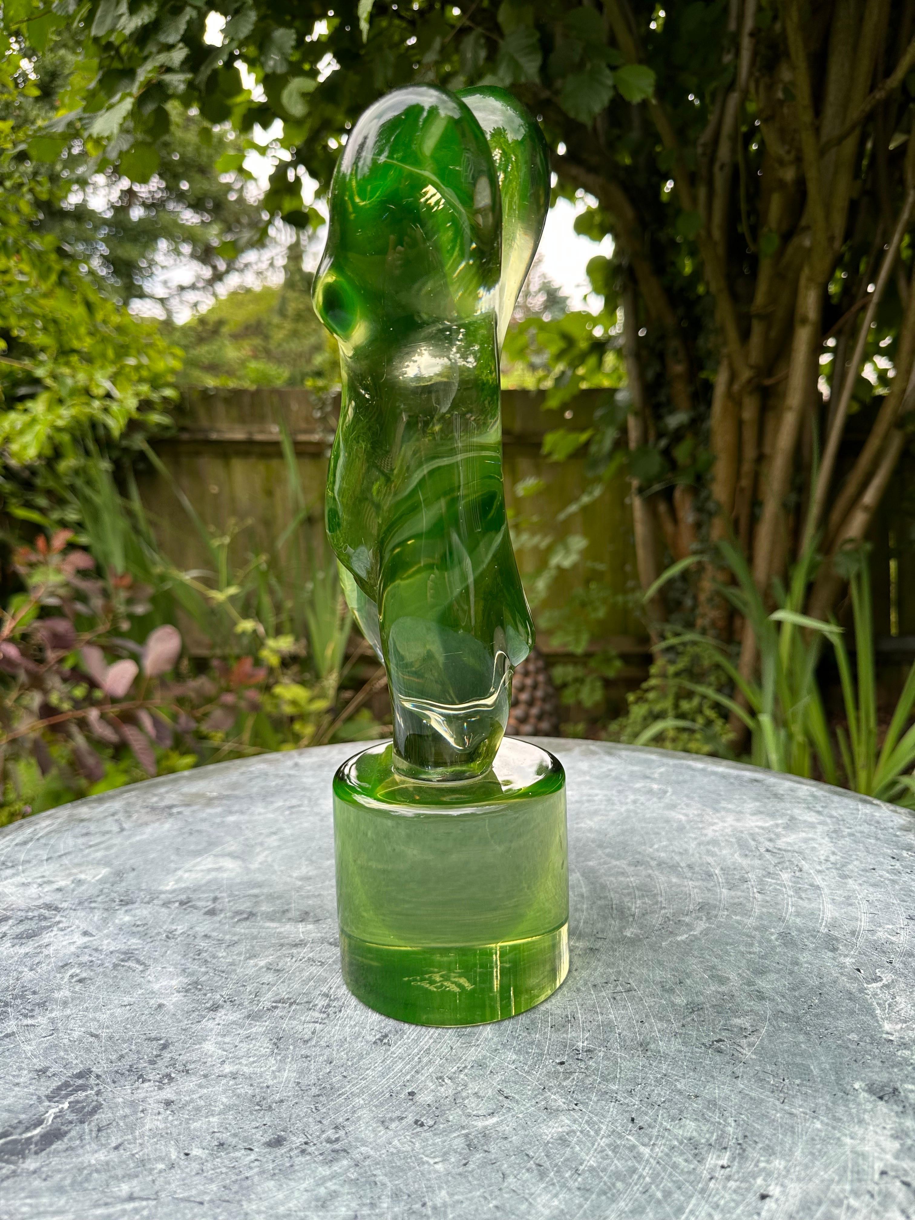 A fine Murano glass figure of a nude lady standing on one leg on a round glass plinth, signed by the artist.