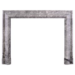 A Grey and White Marble Bolection Fireplace