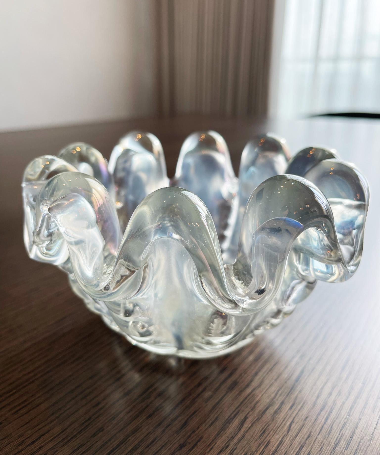 A Murano glass 'Grosse Costolature' bowl by Ercole Barovier.

Created by hand on the the island of Murano, in Italy in the 1940's This piece displays rib like protrusions encircling the bowl; seemingly tenting swathes of thick glass which drape in