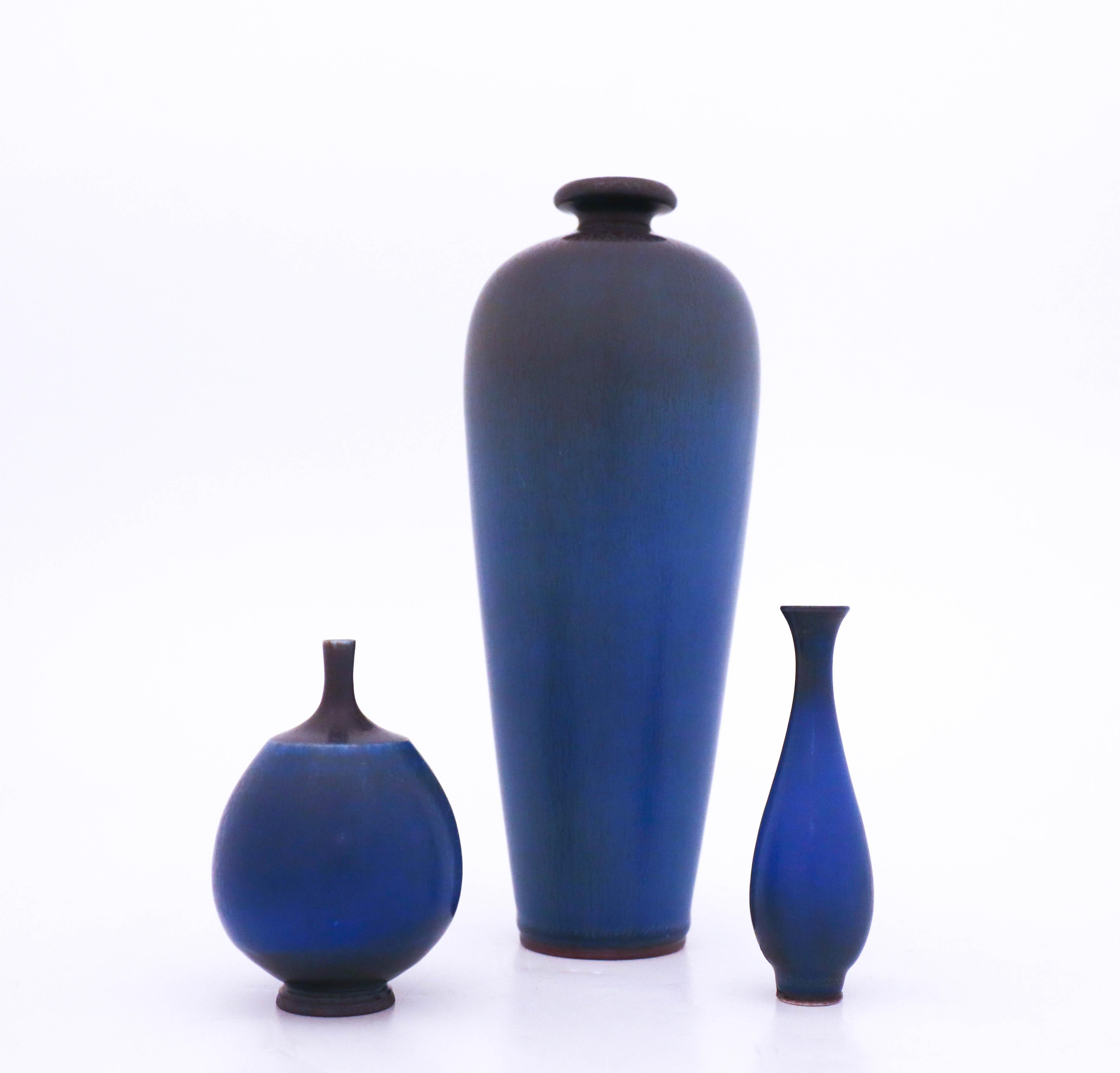 A group of three blue vases designed by Berndt Friberg from Gustavsberg. The vases are 21 cm, 10 cm and 9 cm. They are in very good condition.