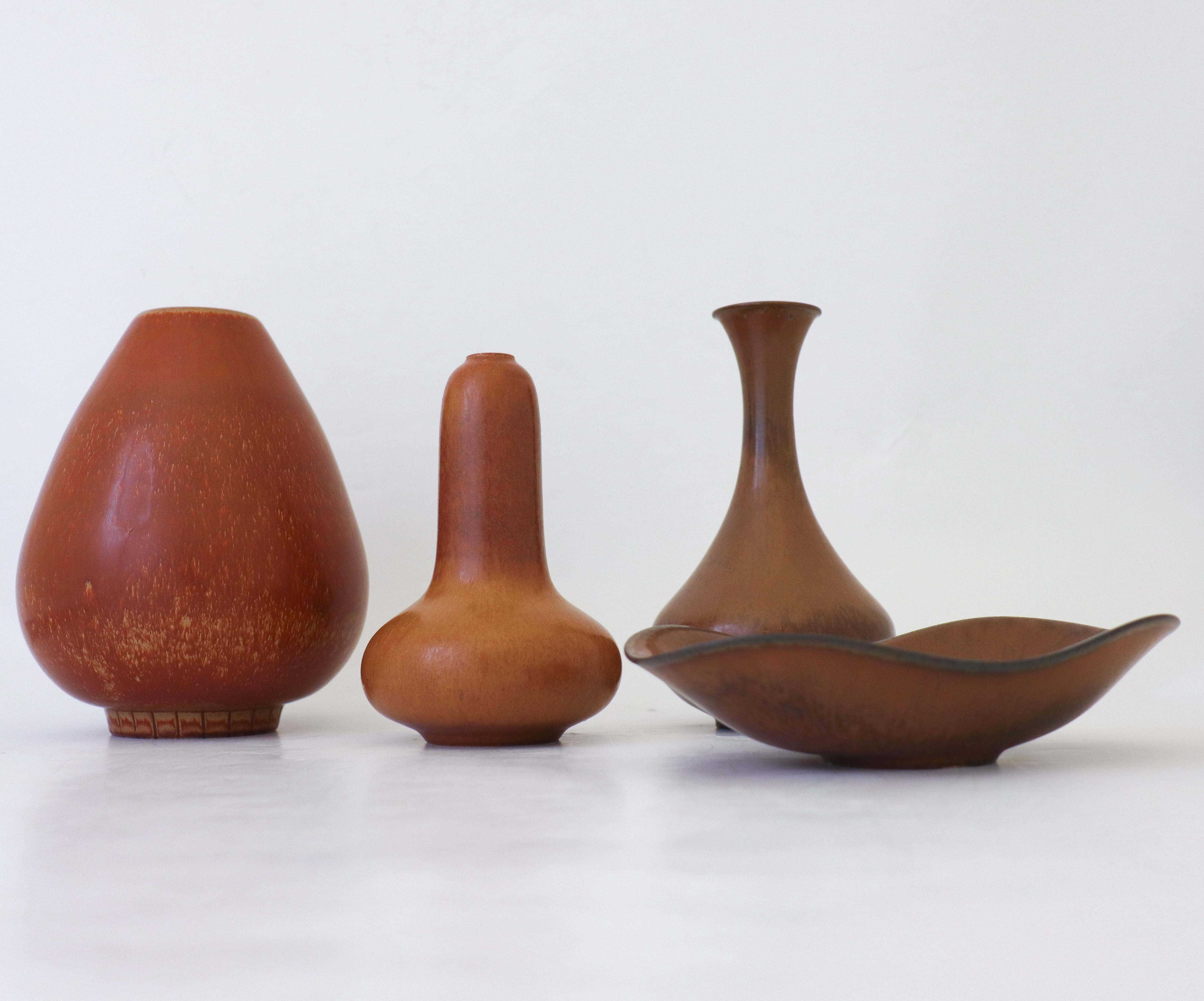 A group of three vases and a bowl in a brown glaze designed by CGunnar Nylund at Rörstrand. The vases are 16.5, 16.5, 7.5 and 14.5 cm high and the bowl is 17.5 x 11 cm in diameter. They are all in excellent condition and first quality. 

Gunnar