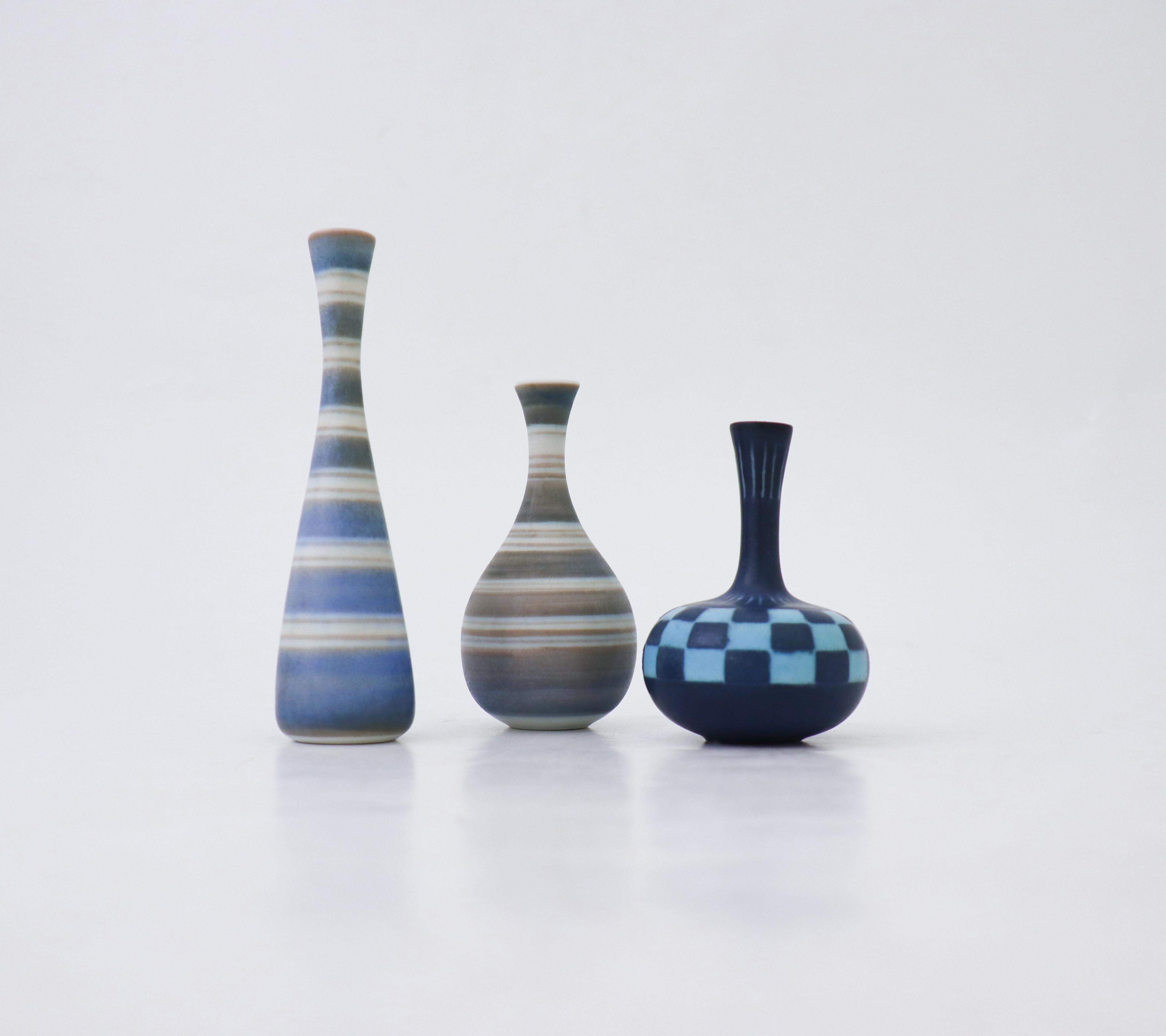 A set of three vases with a graphical pattern designed by Gunnar Nylund at Rörstrand. The vases are 12,5 cm, 9,5 cm and 8 cm high. They are all in excellent condition and marked as 1st quality. 

Gunnar Nylund was born in Paris 1904 with parents who