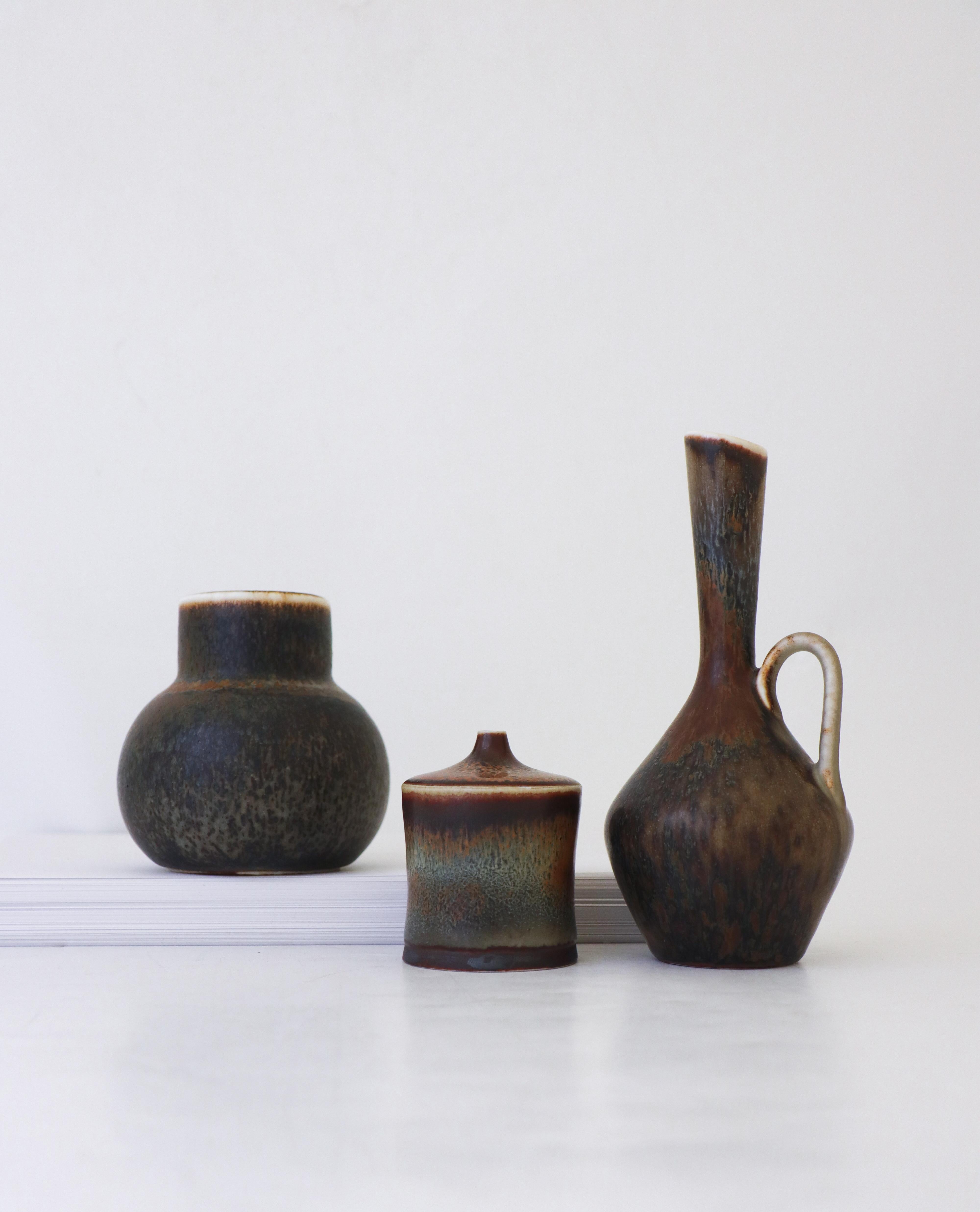 A group of three vases designed by Carl-Harry Stålhane at Rörstrand. They are 18 cm, 10 cm and 7.5 cm high and in excellent condition. The vase to the left is 2nd quality, the one in the middle is a unique vase and both that one and the one to the