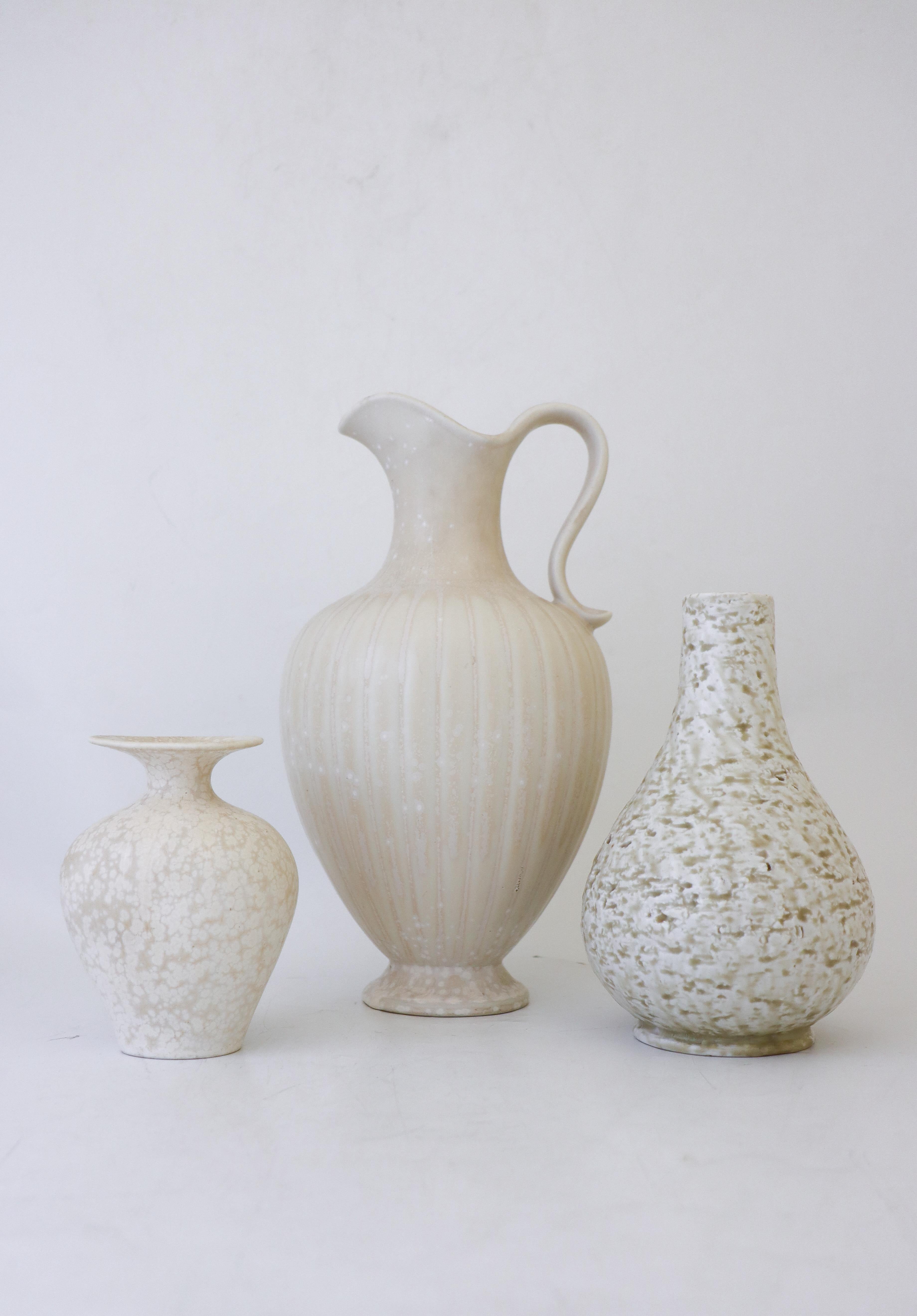A group of three white vases designed by Gunnar Nylund at Rörstrand. The vases are 28, 19 and 12.5 cm high. They are all in excellent condition and marked as 1st quality. 

Gunnar Nylund was born in Paris 1904 with parents who worked as sculptors