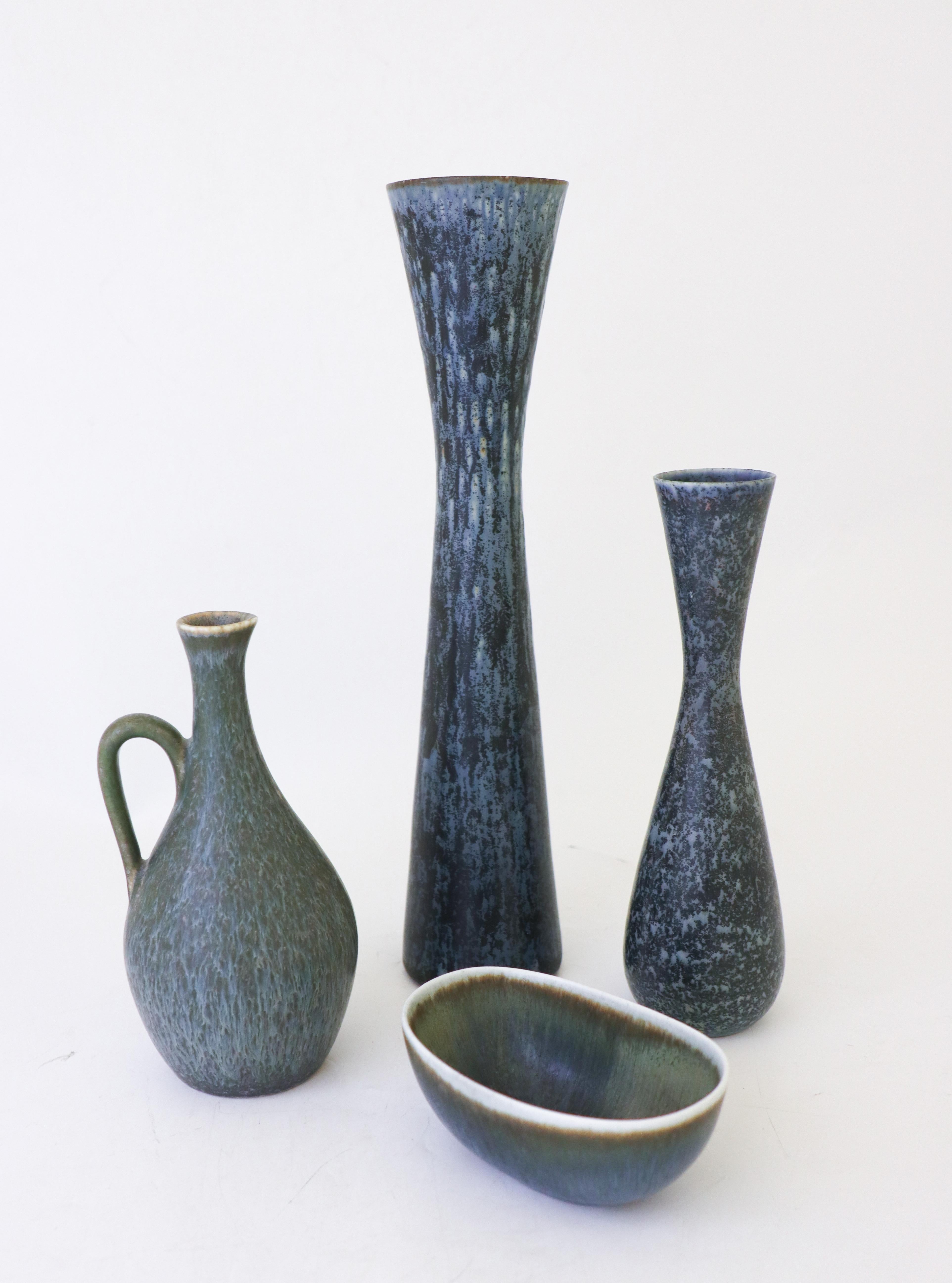 A group of three vases and a bowl designed by Carl-Harry Stålhane at Rörstrand. The vases are 31 cm, 20.5 cm and 17 cm high and the bowl is 11 x 7 cm and in excellent condition. They are all in excellent condition and first quality. 

Carl-Harry
