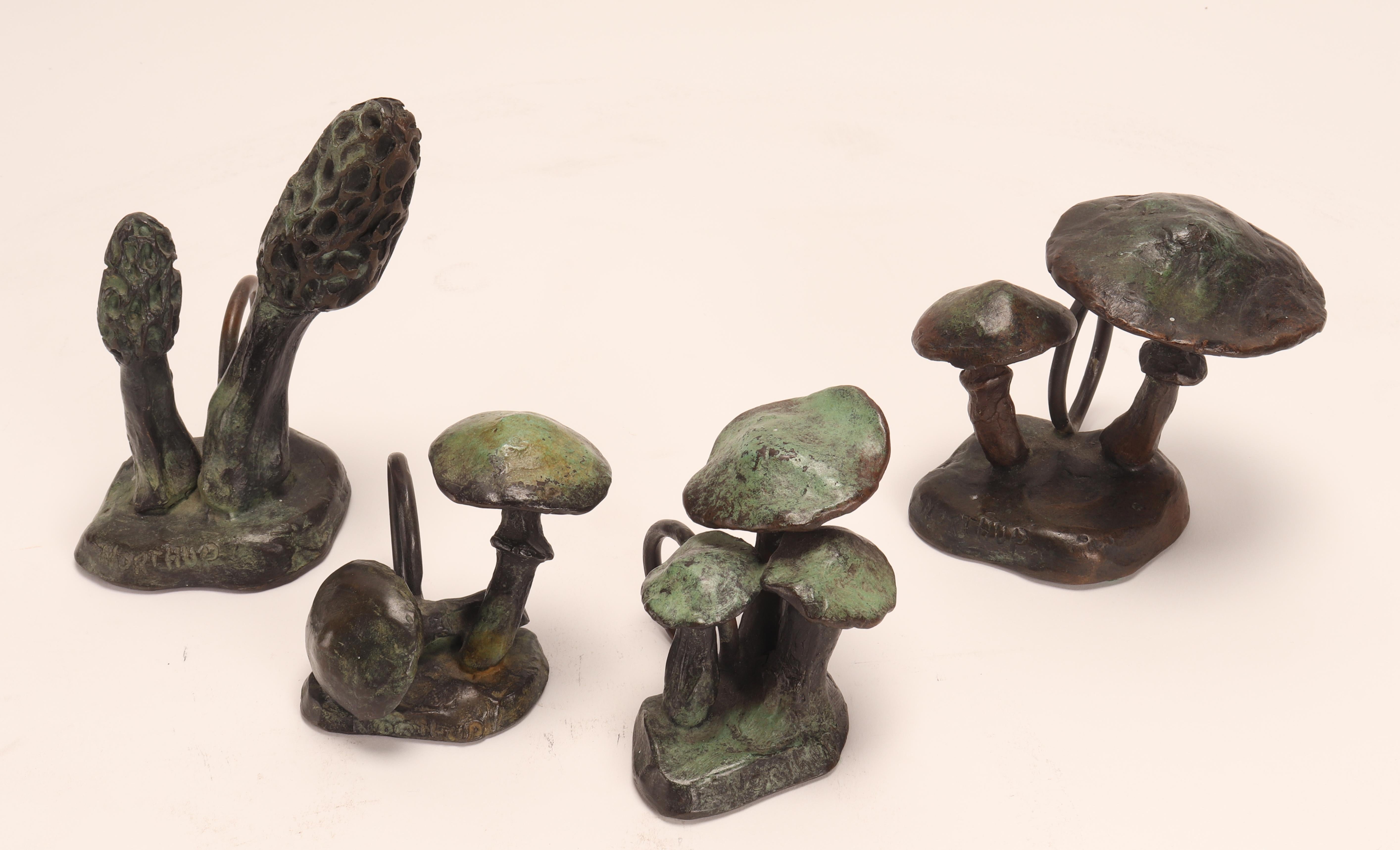 A group of four sculptures with the function of napkin holder, made by George Northup (1940-2017) in bronze, depicting mushrooms. United States of America circa 1960.