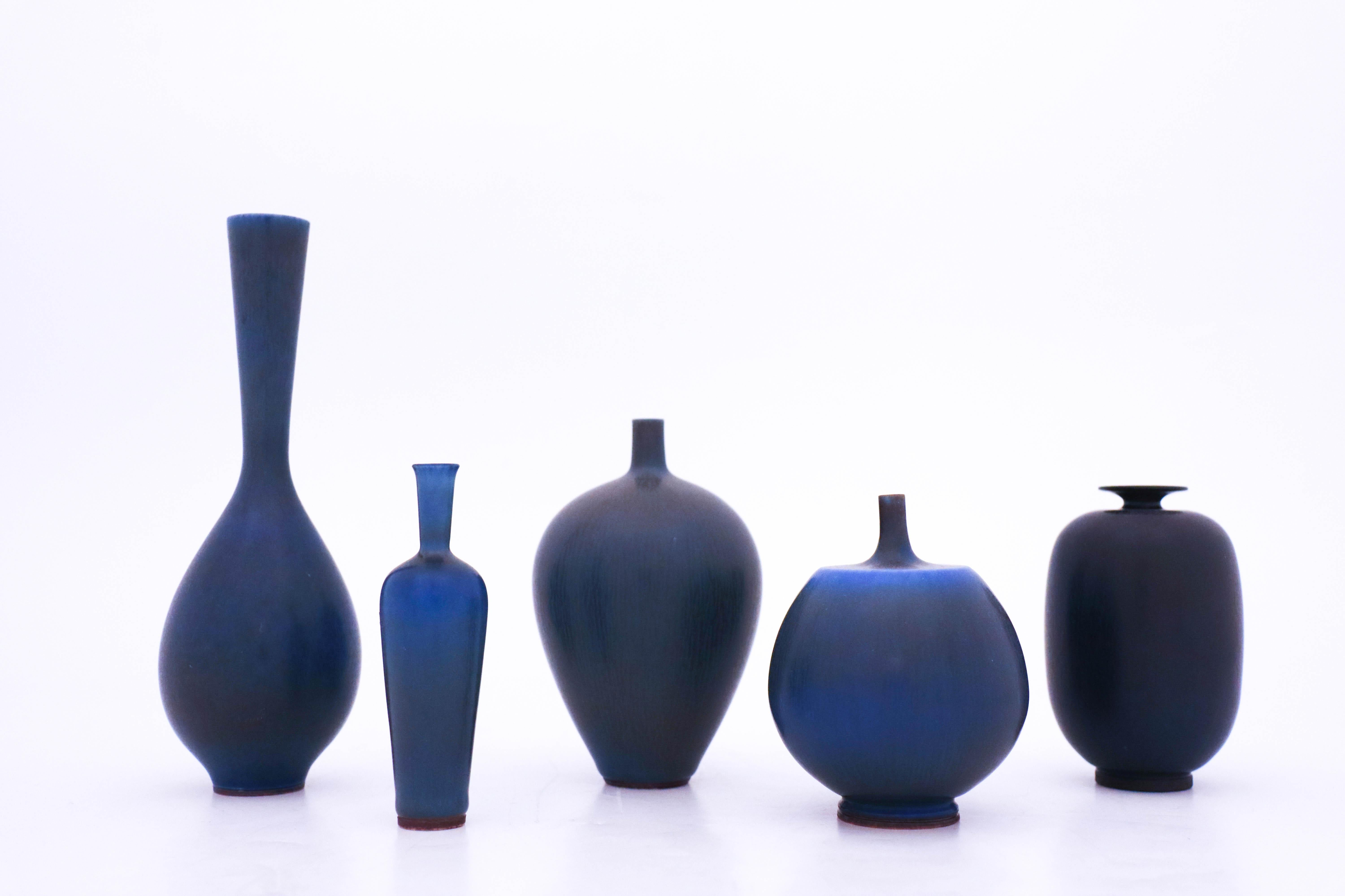 A group of five vases designed by Berndt Friberg from Gustavsberg. The vases are 18 cm, 11 cm, 10 cm, 9.5 cm, and 9.5 cm. They are in very good condition.