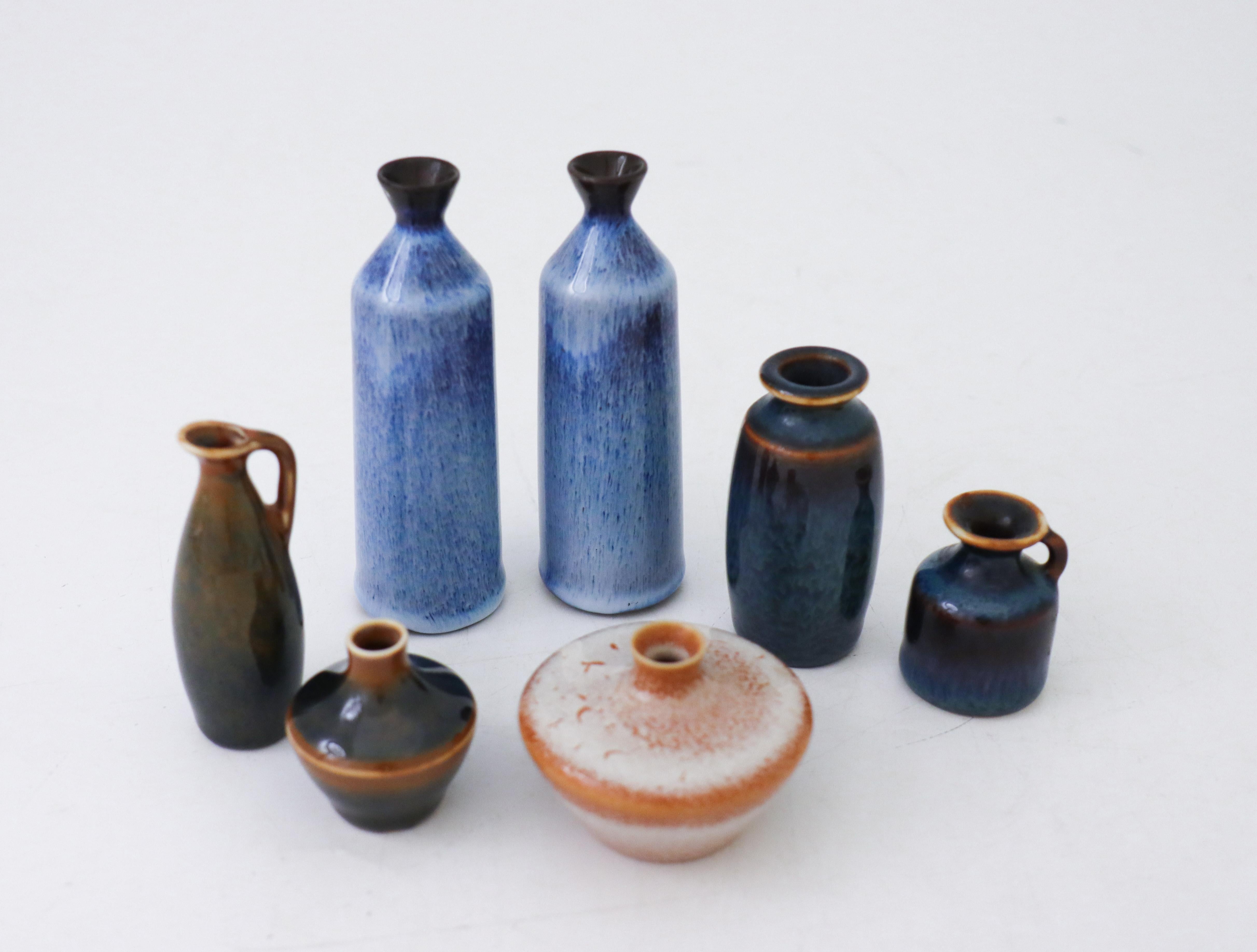 A group of seven vases with shiny glaze in different colors. They are between 10-4 cm high. Four of them are designed by Carl-Harry Stålhane, 2 of them are designed by Gunnar Nylund and one by Bertil Lundgren, all of them at Rörstrand, Sweden. They
