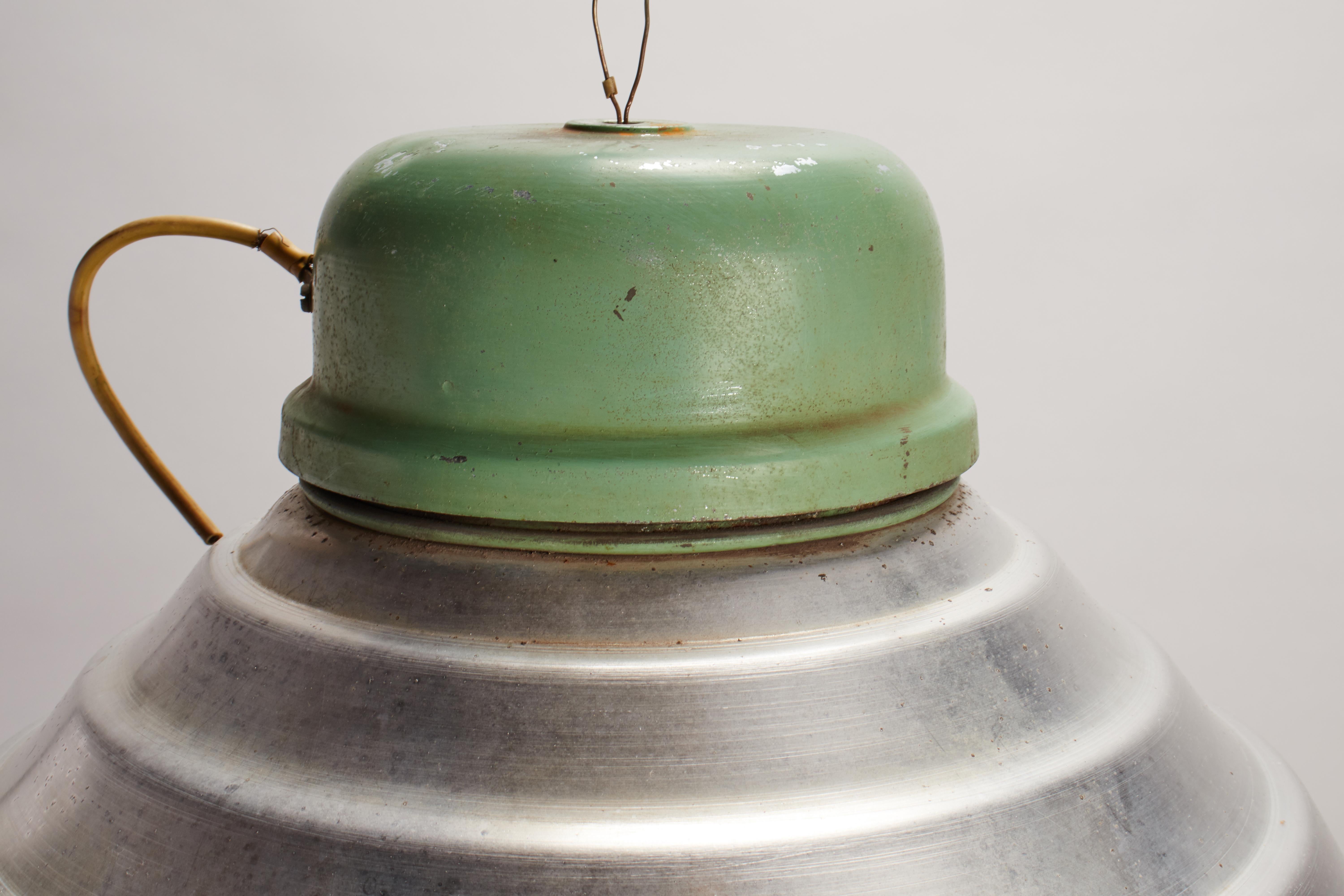 A group of swinging industrial lamps, green enamel over aluminum dome. Iron hanging hook, porcelain wheel metal wire. Sold also separately. Italy 1920 ca.