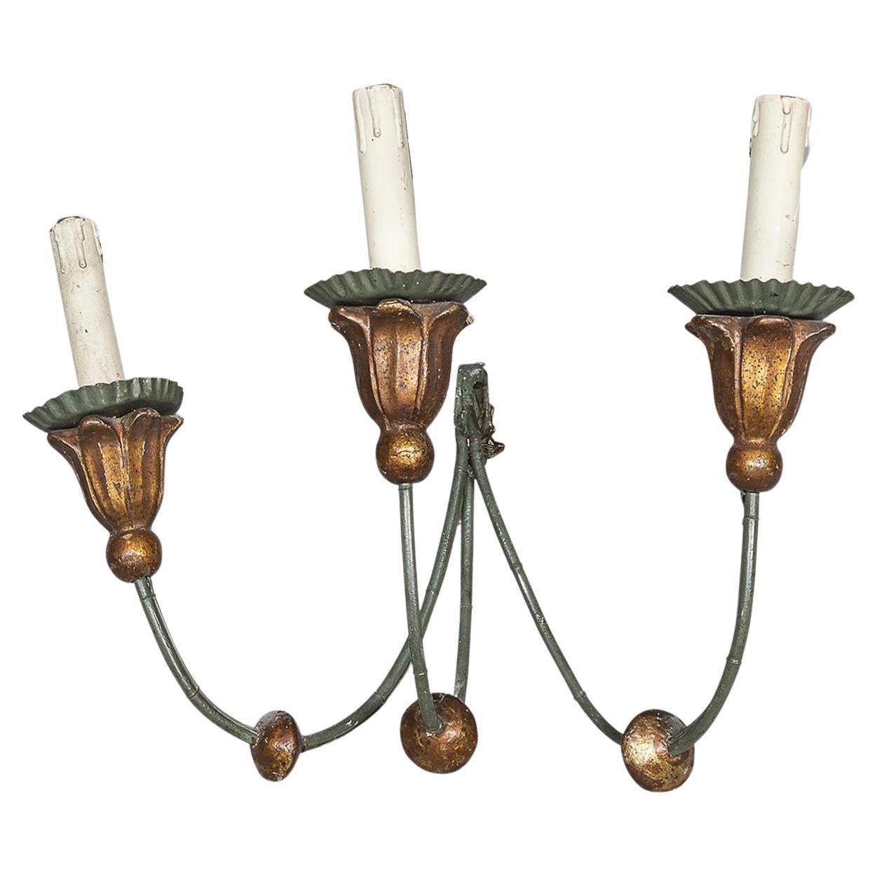 Anonymous
19th century; Europe
Iron and gilt wood

Approximate size: 9.5 (h) x 15 (w) x 9.75 (d) inches

A collection of five eloquent antique European wall lights in the form of 3-light candlesticks. The iron armatures are painted with a green