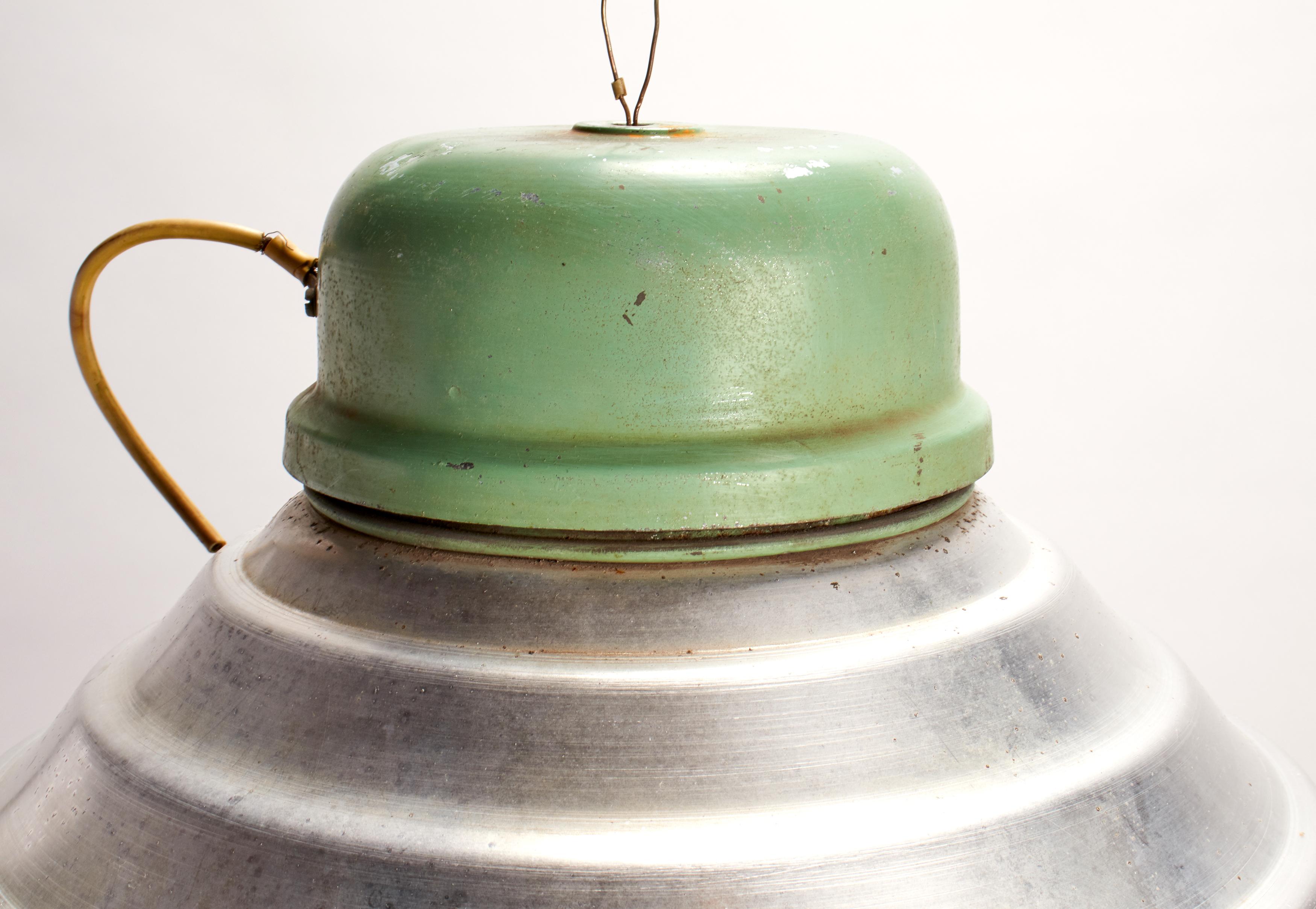 A Group of swinging industrial lamps, green enamel over aluminum dome. Iron hanging hook, porcelain wheel metal wire. Sold also separately, Italy, circa 1920.