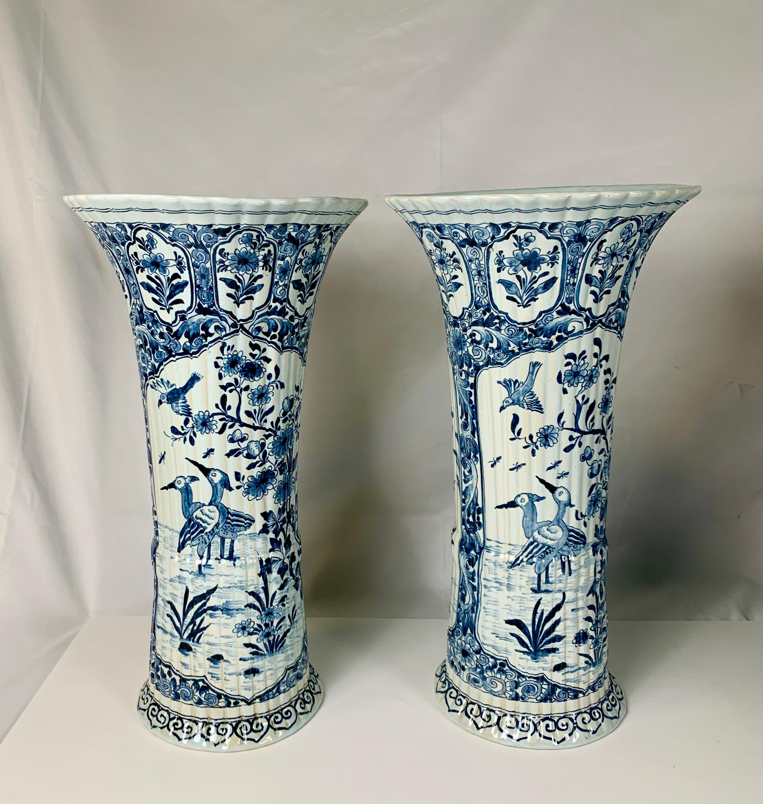 A Group of Dutch Delft jars and open vases late 18th to 20th centuries
The price for the group is $10,700
A] in the center front, a pair of Dutch Delft mantle vases with leopard finials made circa 1850, condition: tiny edge frits, 
13.5